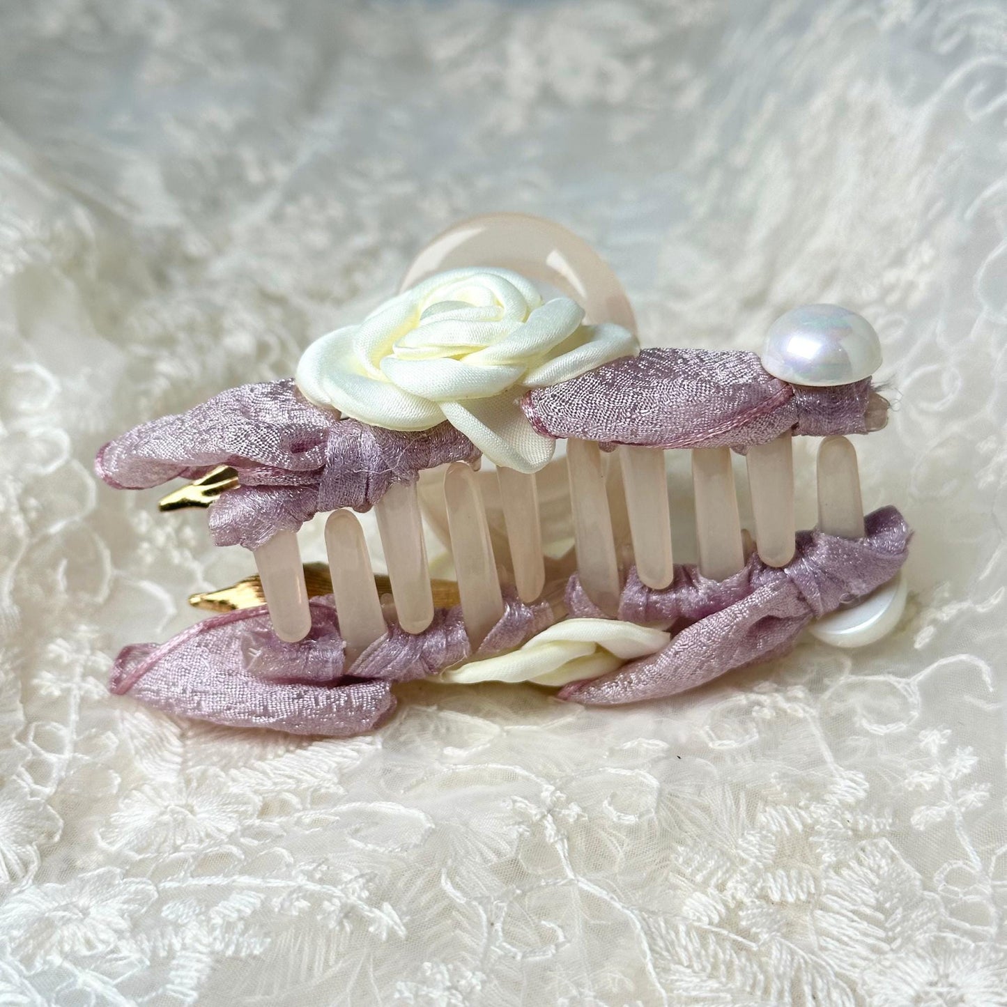 a close up of a hair comb with a flower on it