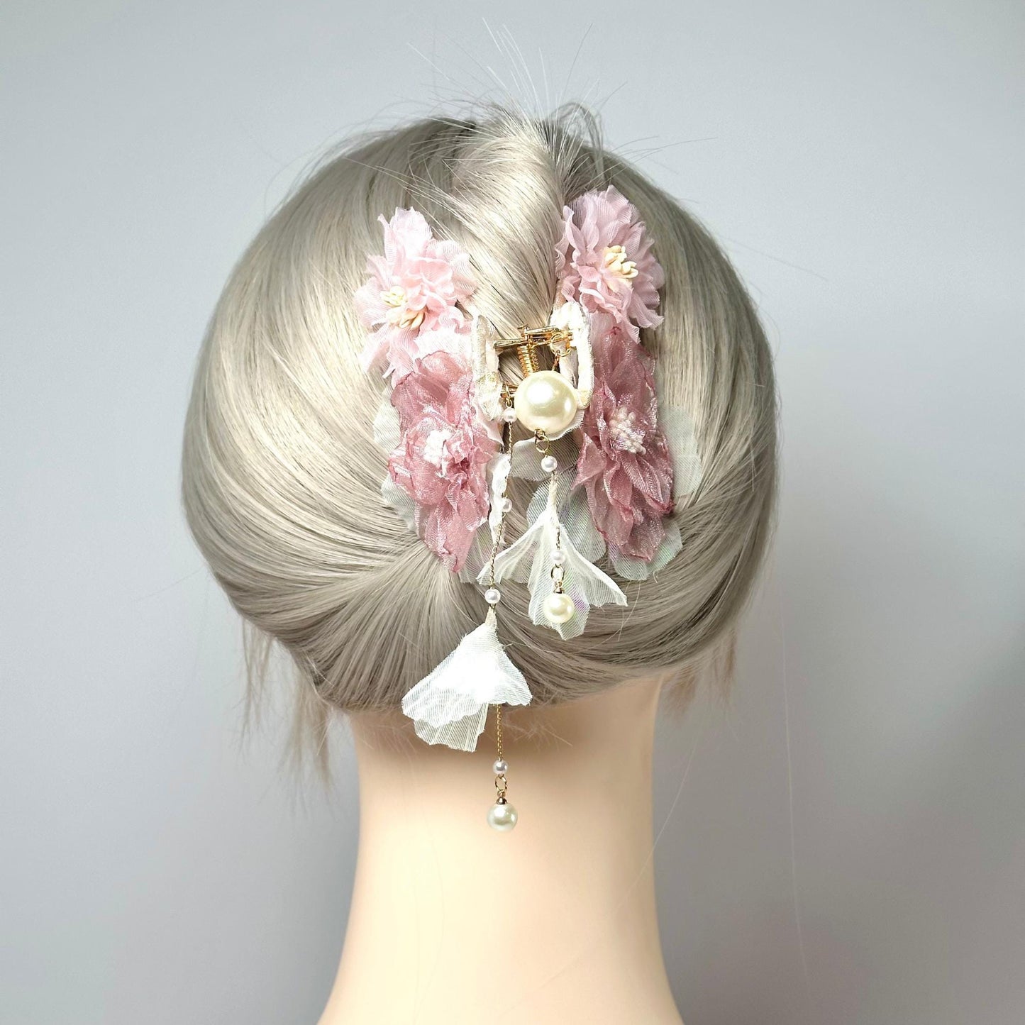 a close up of a mannequin head with flowers on it
