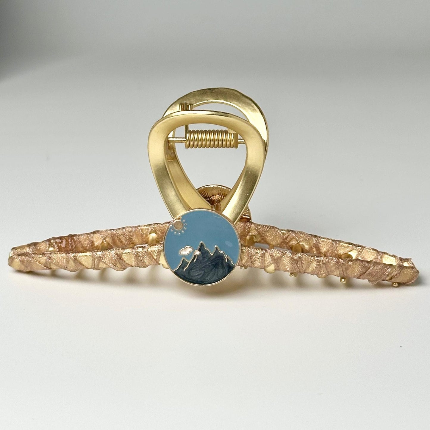 a gold ring with a blue stone in the middle
