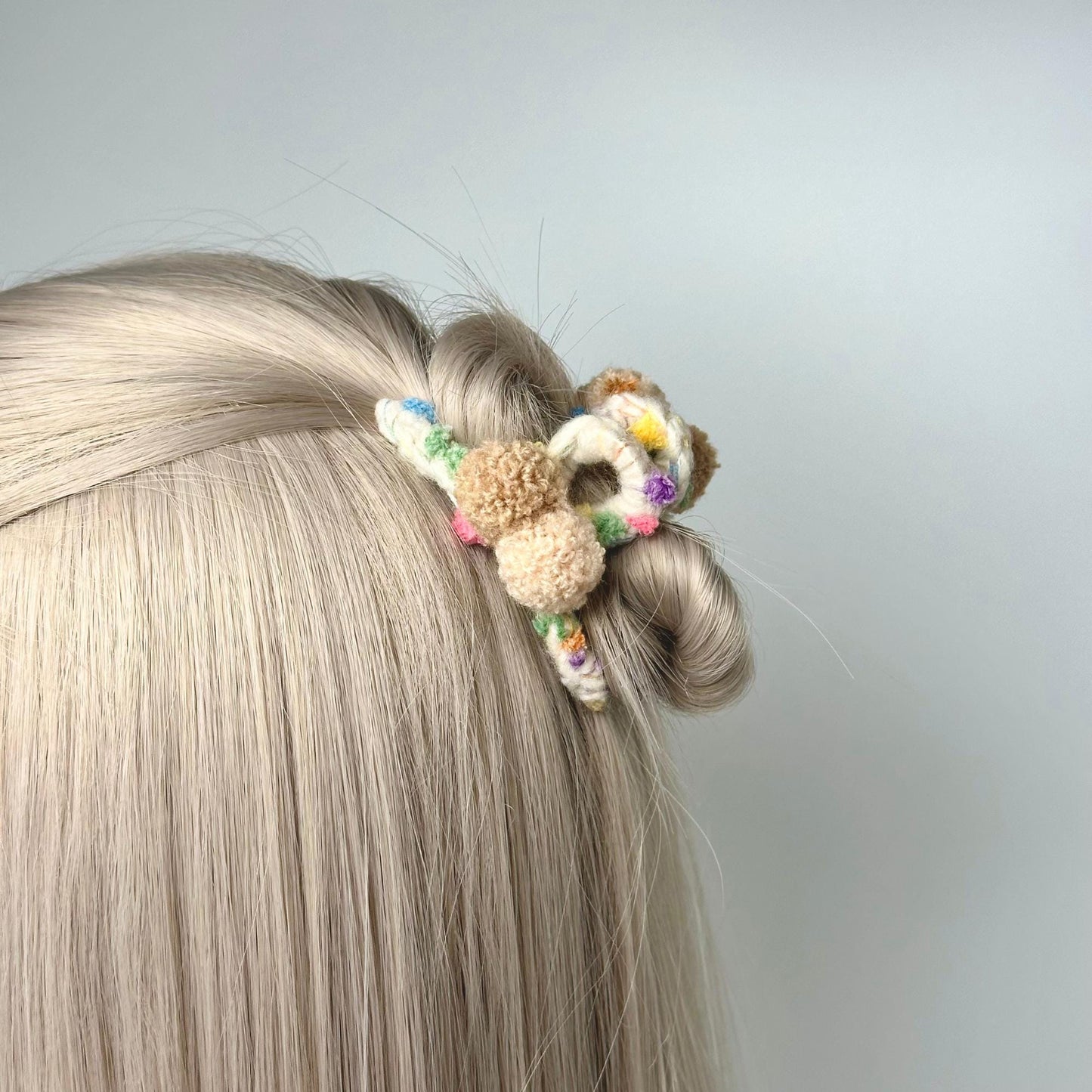 a woman with blonde hair has a stuffed animal in her hair