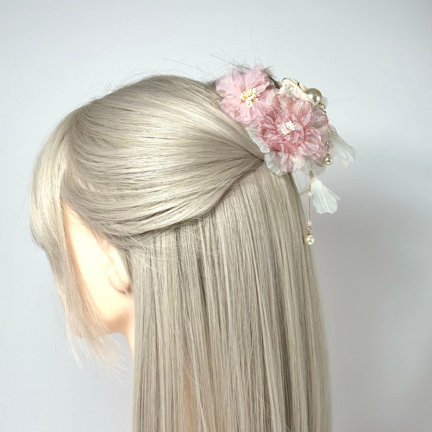 a blonde woman with a flower in her hair
