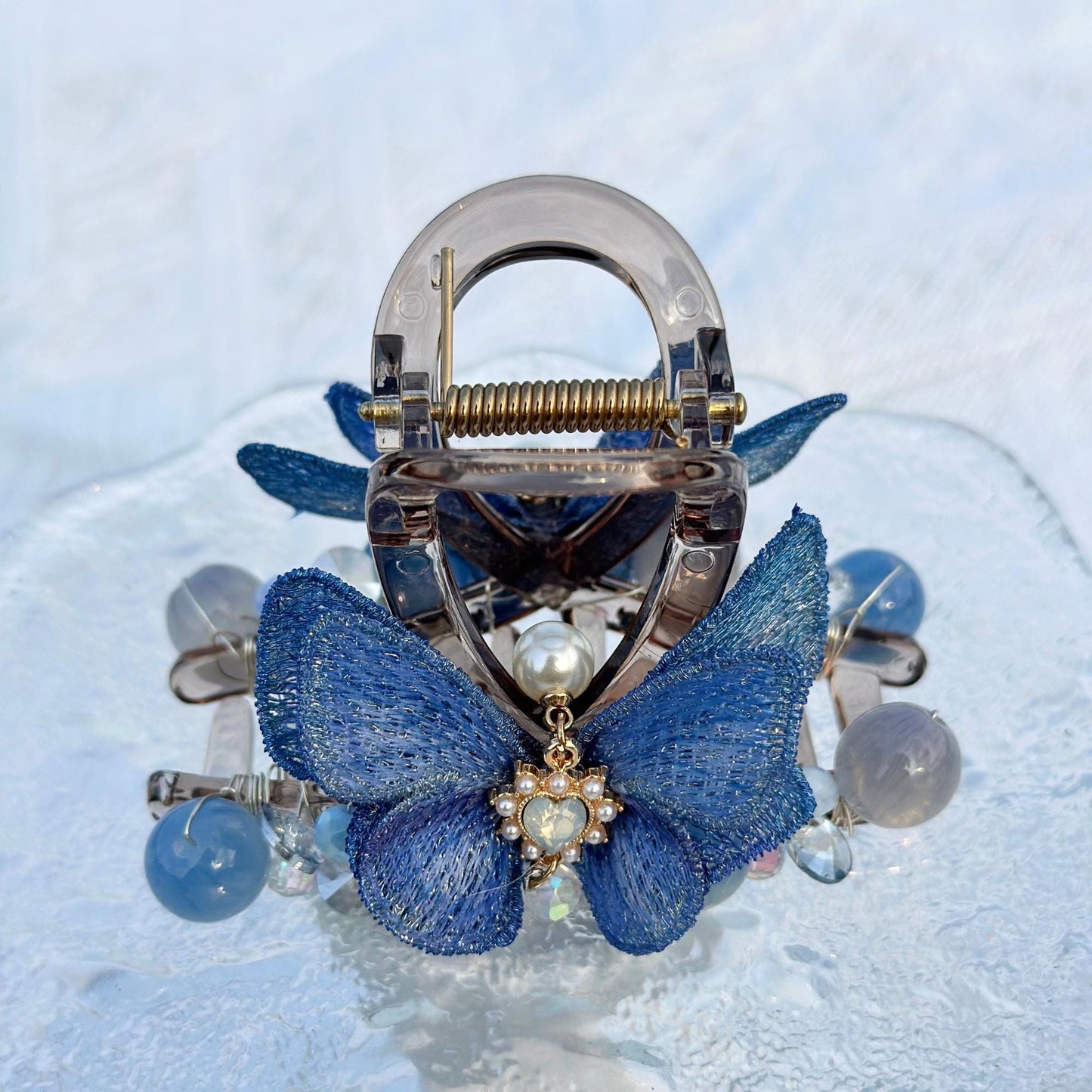 a close up of a blue butterfly brooch