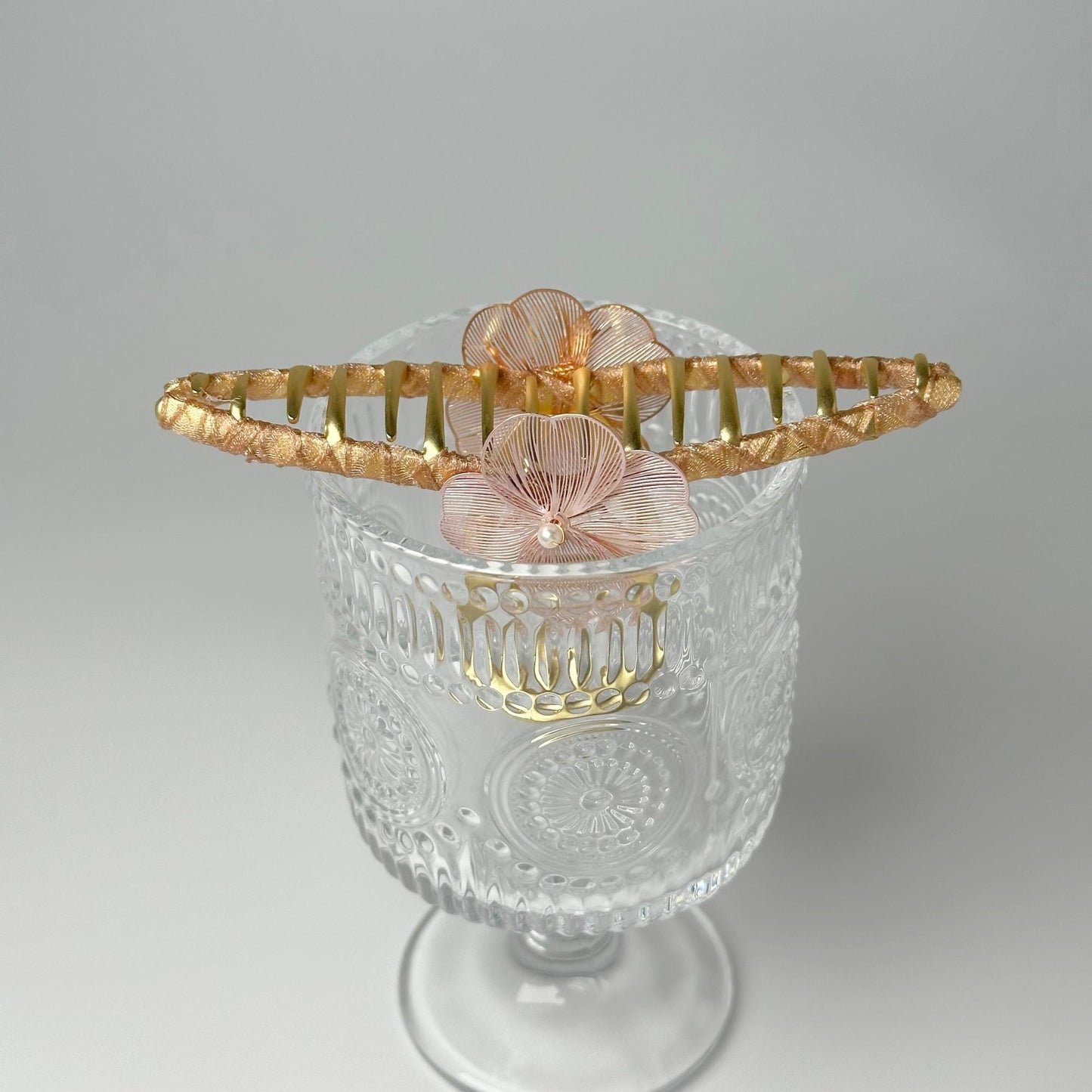 a glass vase with a flower in it