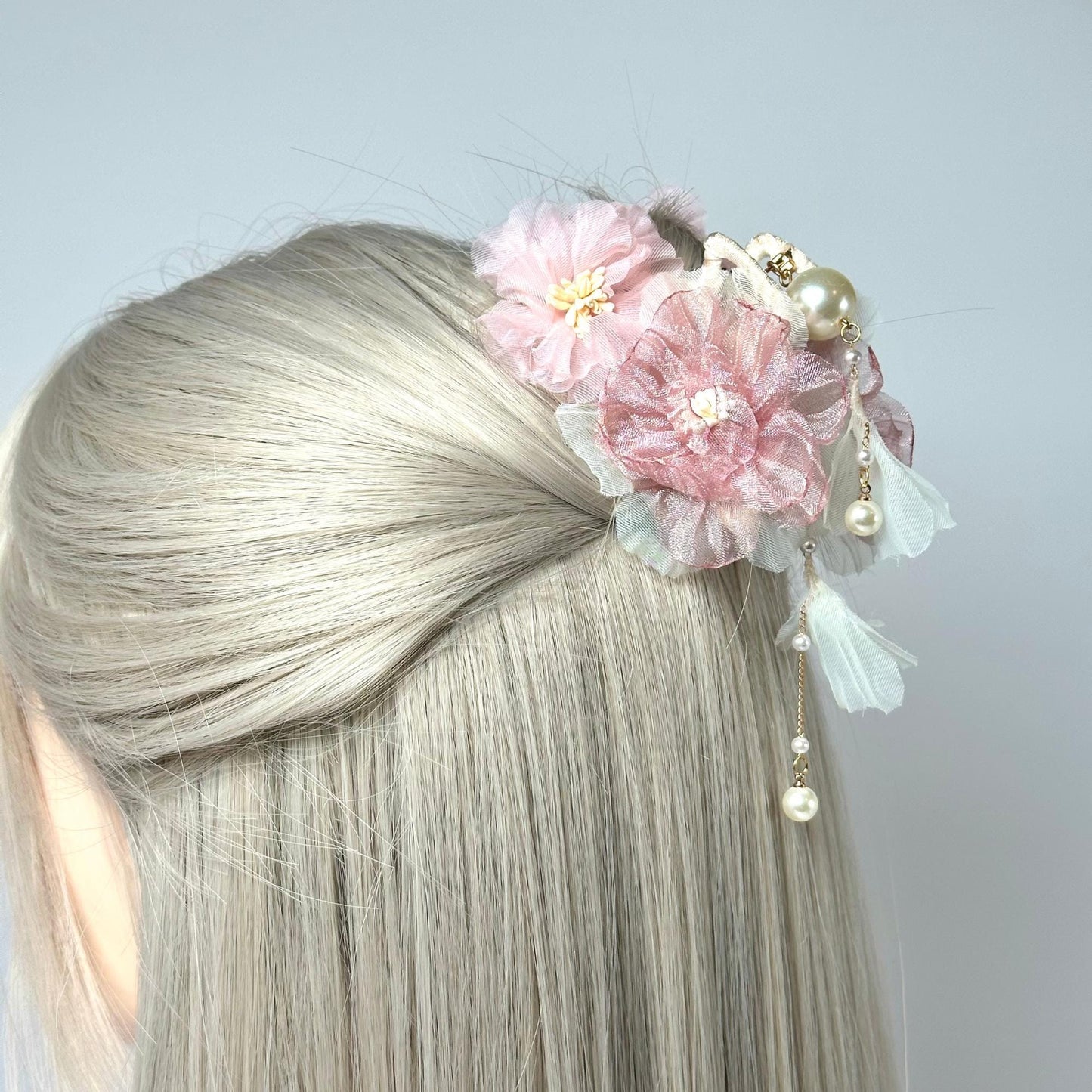 a woman with blonde hair and a flower in her hair