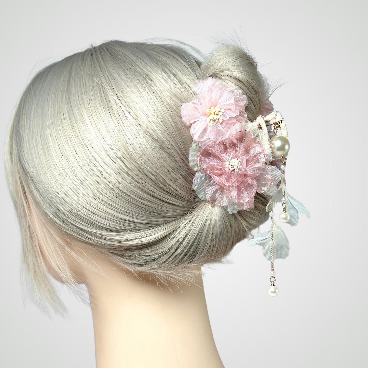 a close up of a woman with a flower in her hair