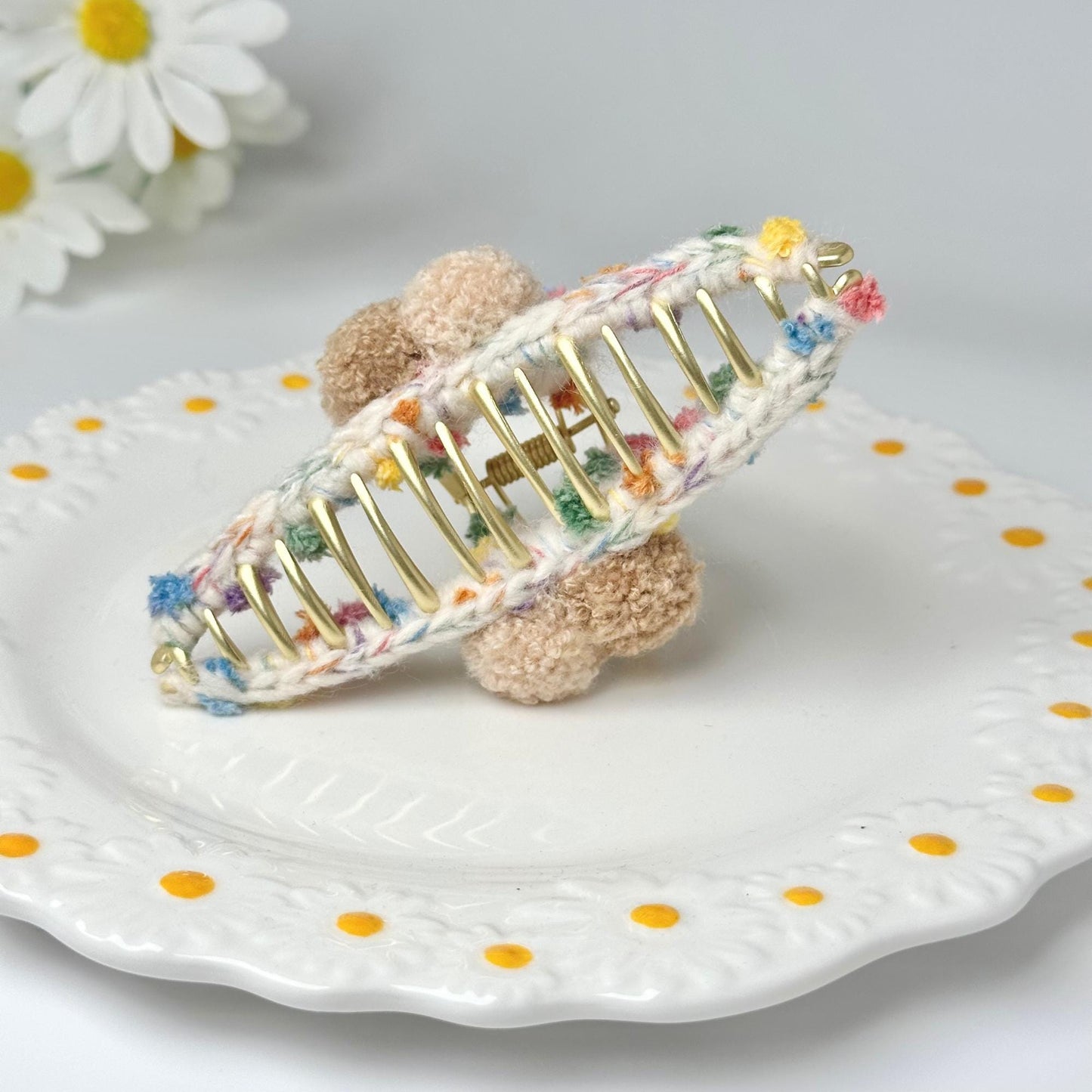 a small teddy bear sitting on top of a white plate
