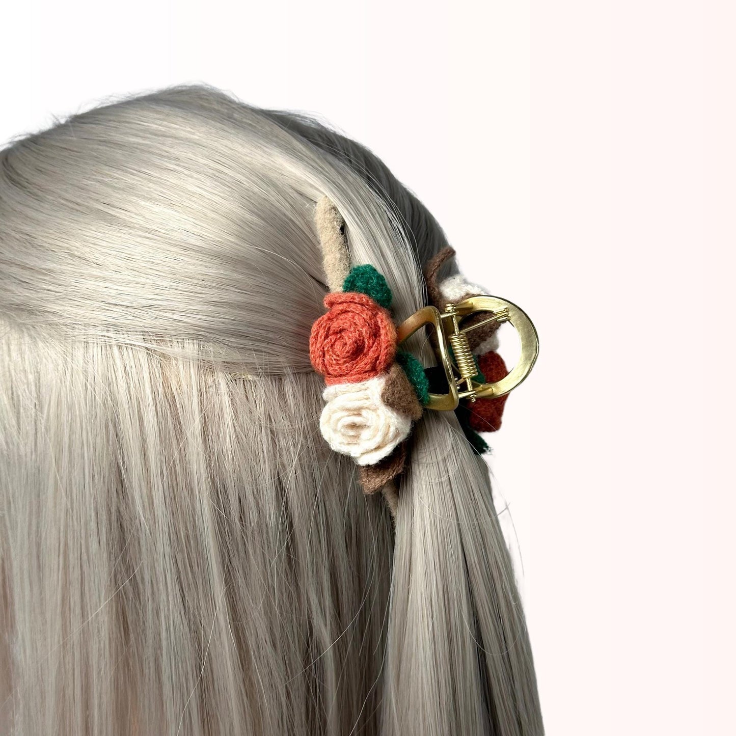 a close up of a woman's hair with a flower in it