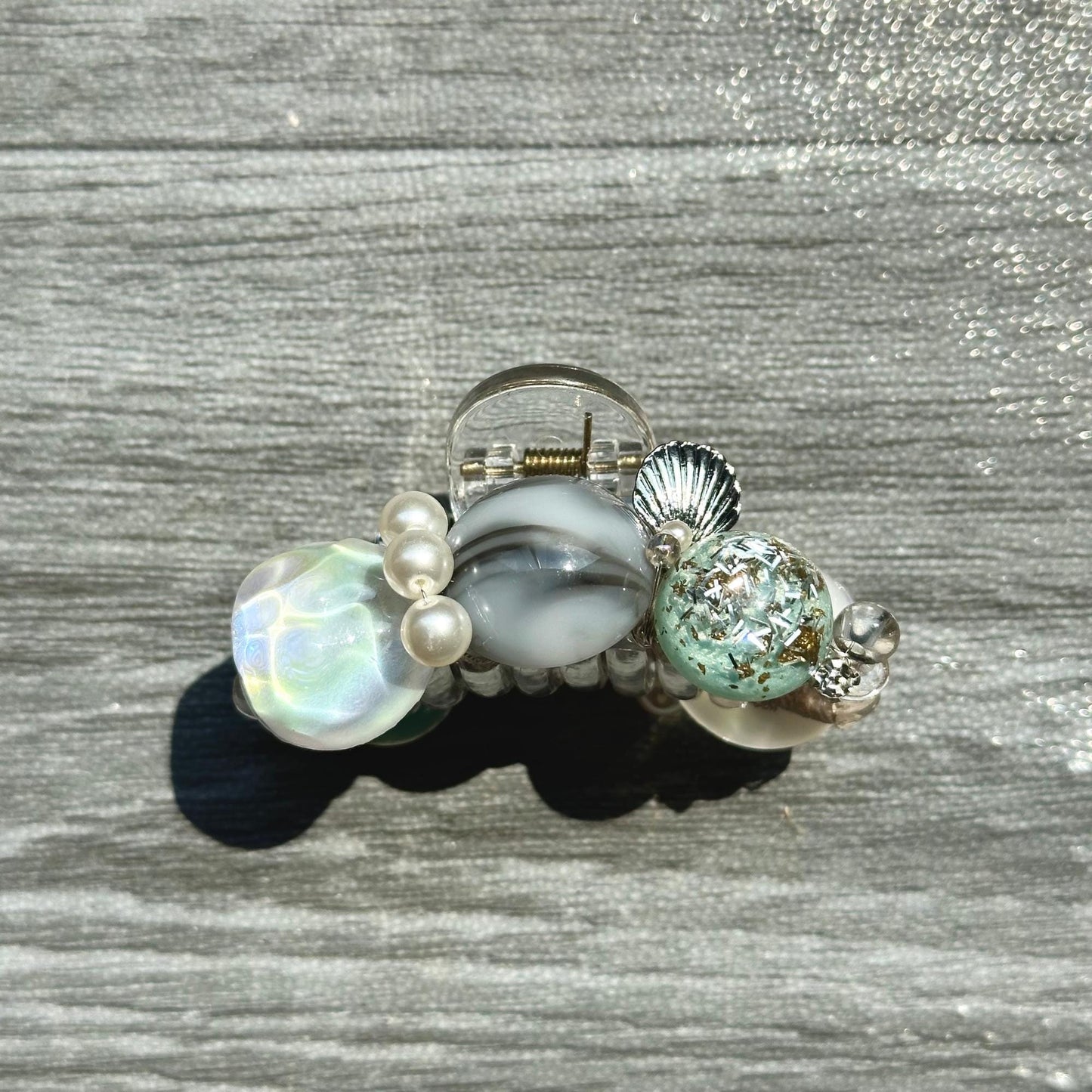 a ring with a shell and pearls on it