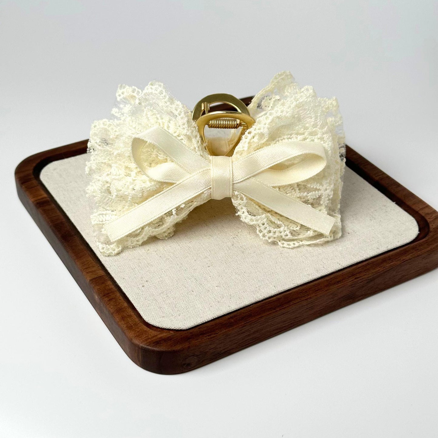 a wooden tray with a ring on top of it