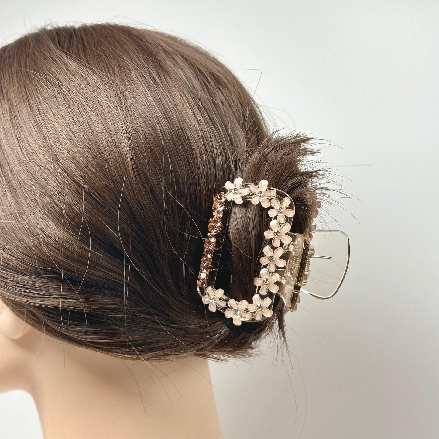 a close up of a woman's head wearing a hair clip