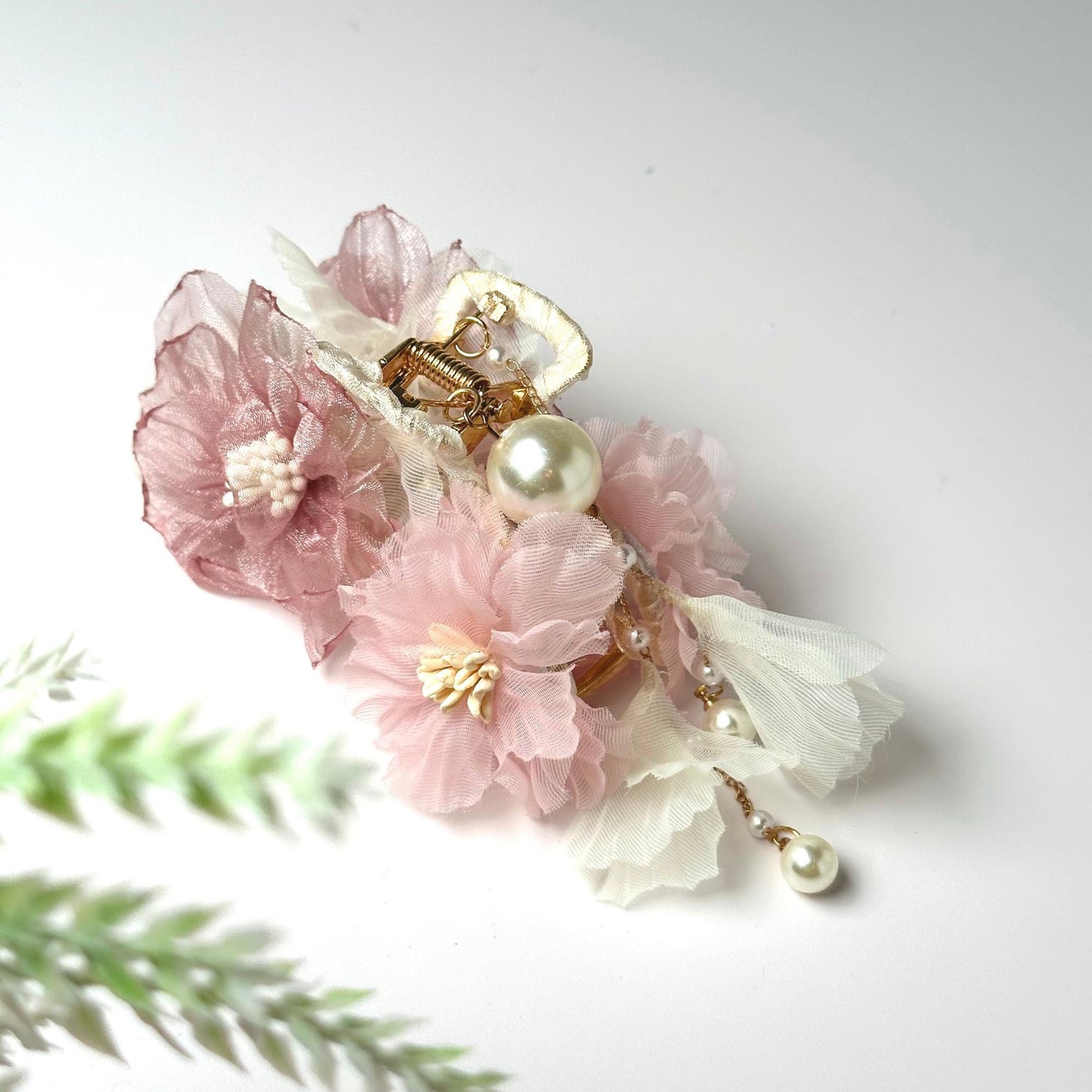 a bouquet of flowers with pearls and pearls