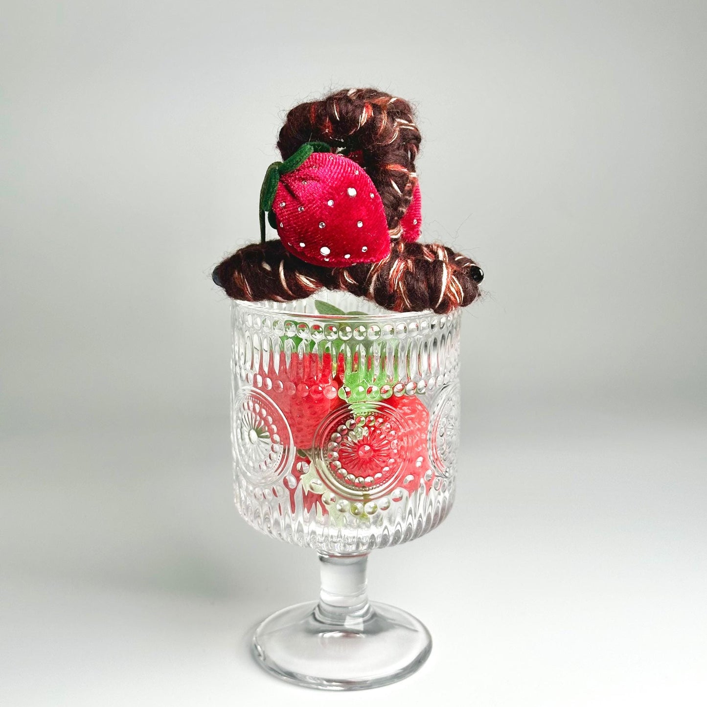 a glass vase with some strawberries in it