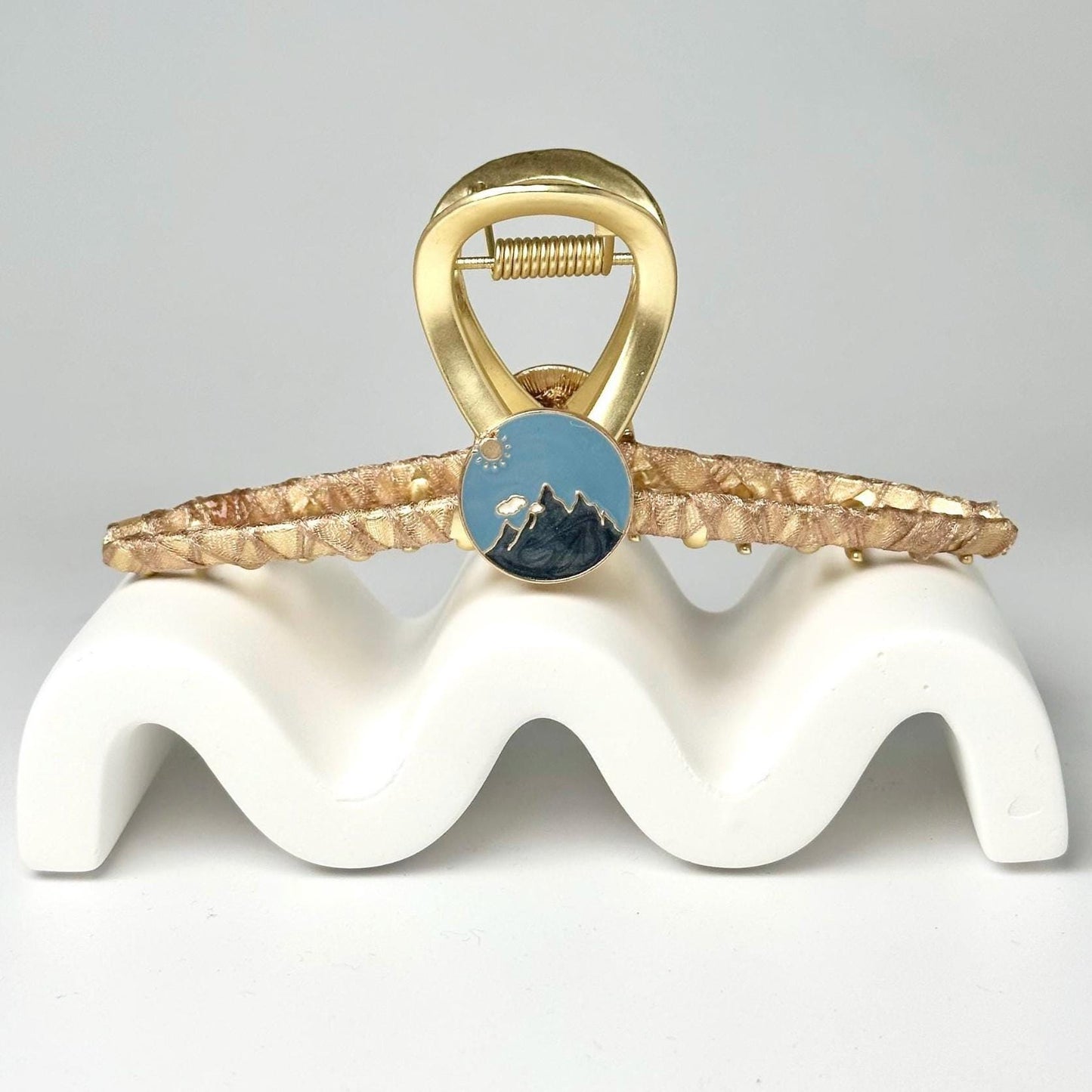 a gold ring with a blue stone on it