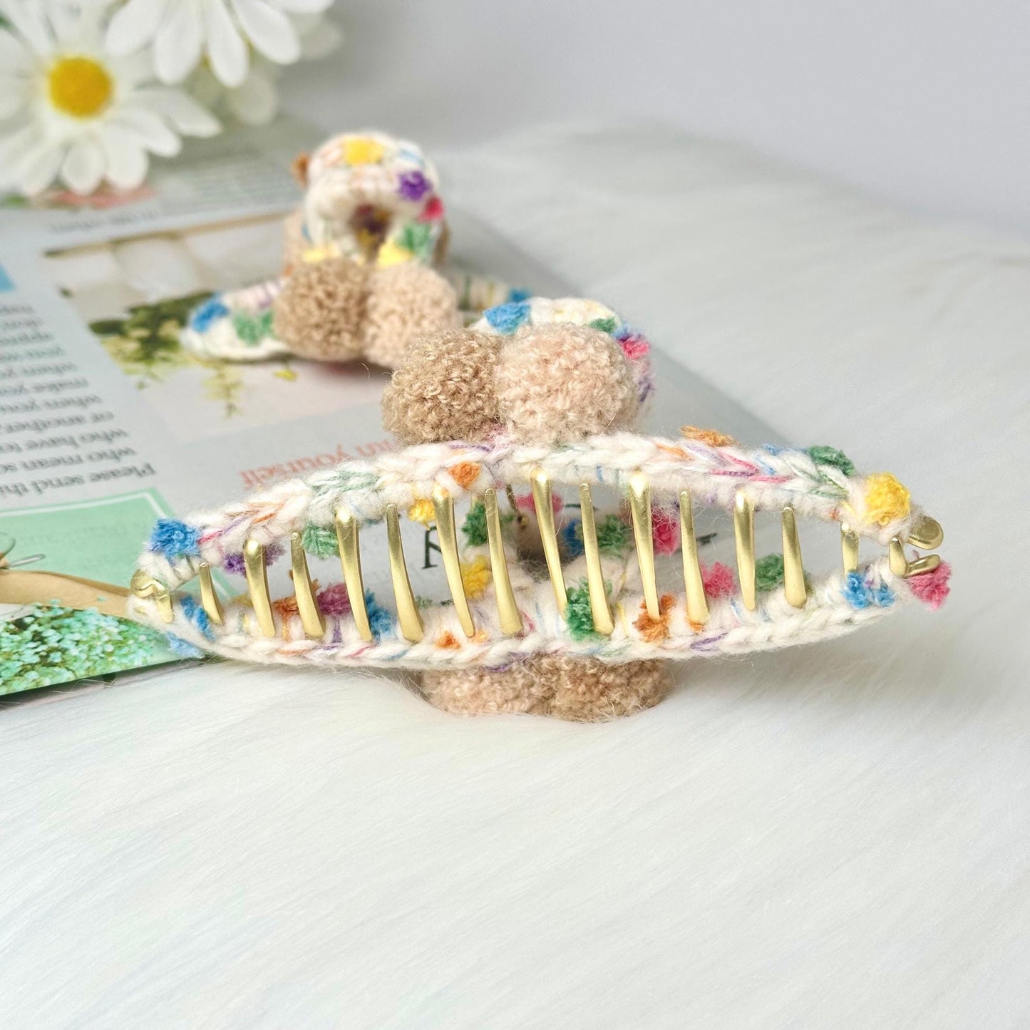 a crocheted hair comb with a teddy bear on top of it