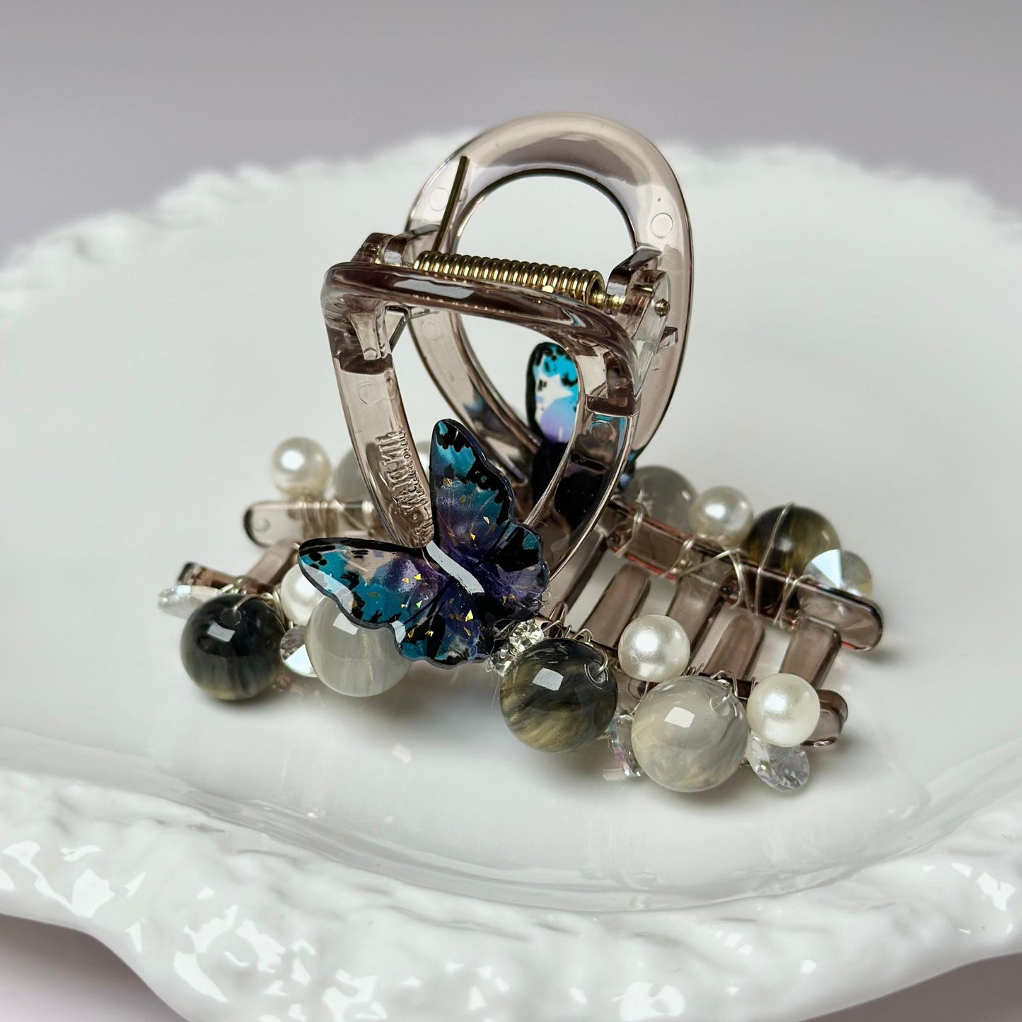 a close up of a brooch on a plate