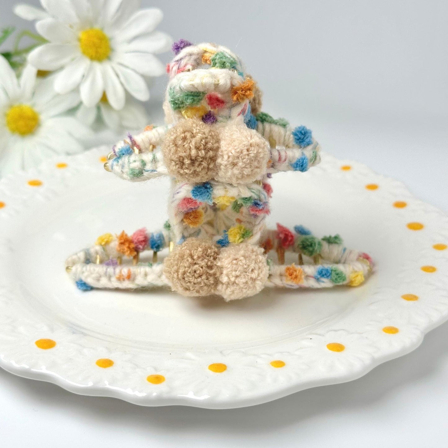 a small stuffed animal sitting on top of a white plate