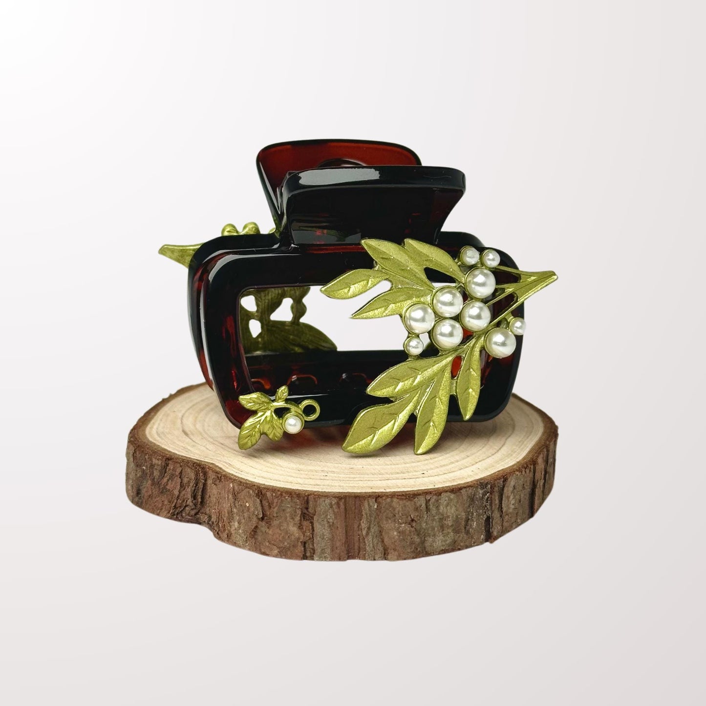 a black vase sitting on top of a tree stump