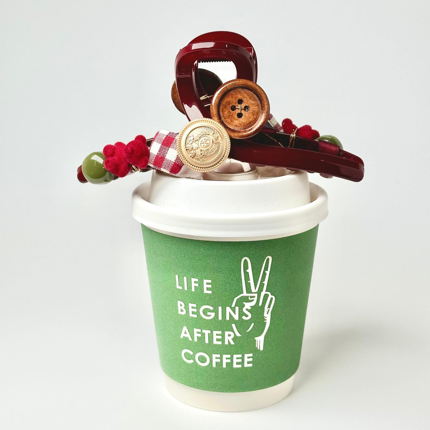 a cup of coffee with buttons and a pair of scissors