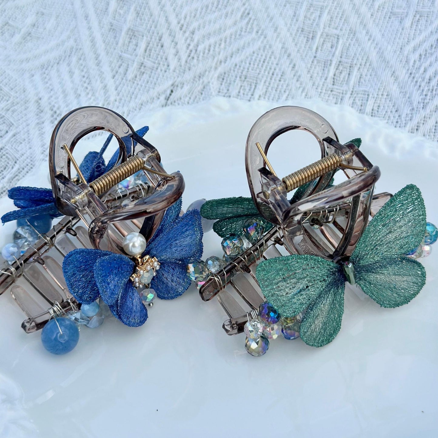 a close up of two hair clips on a plate