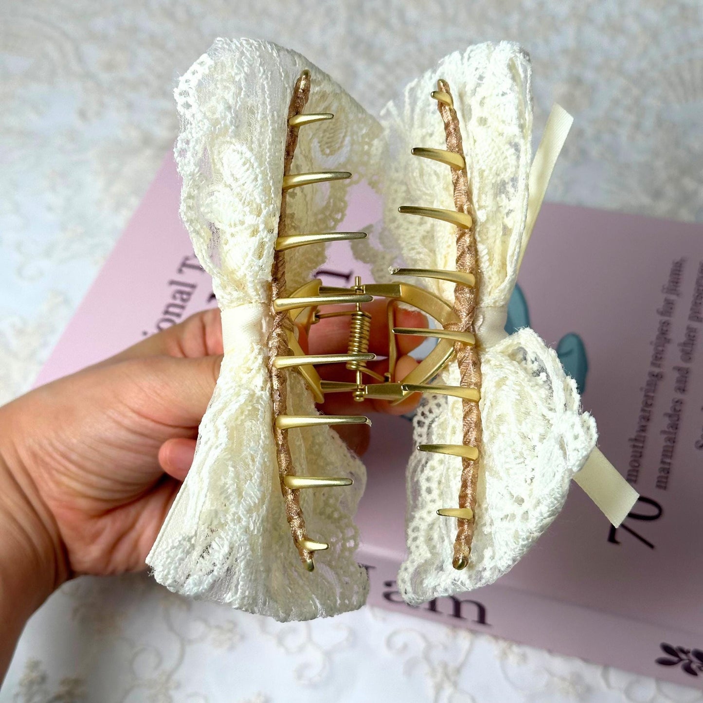 a person is holding a piece of fabric with a piece of wire attached to it
