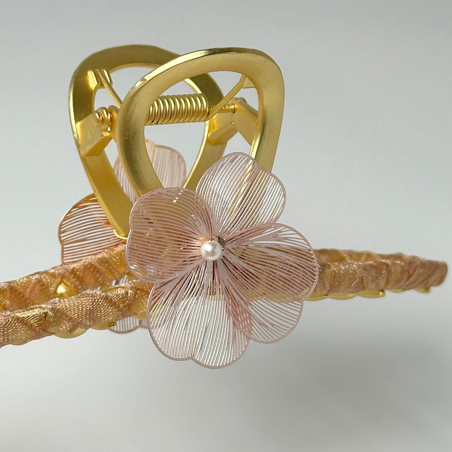 a gold ring with a flower attached to it