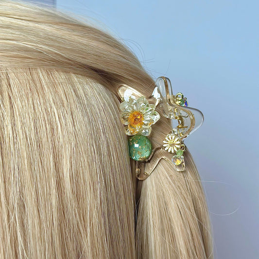 a woman with blonde hair wearing a hair clip with flowers on it