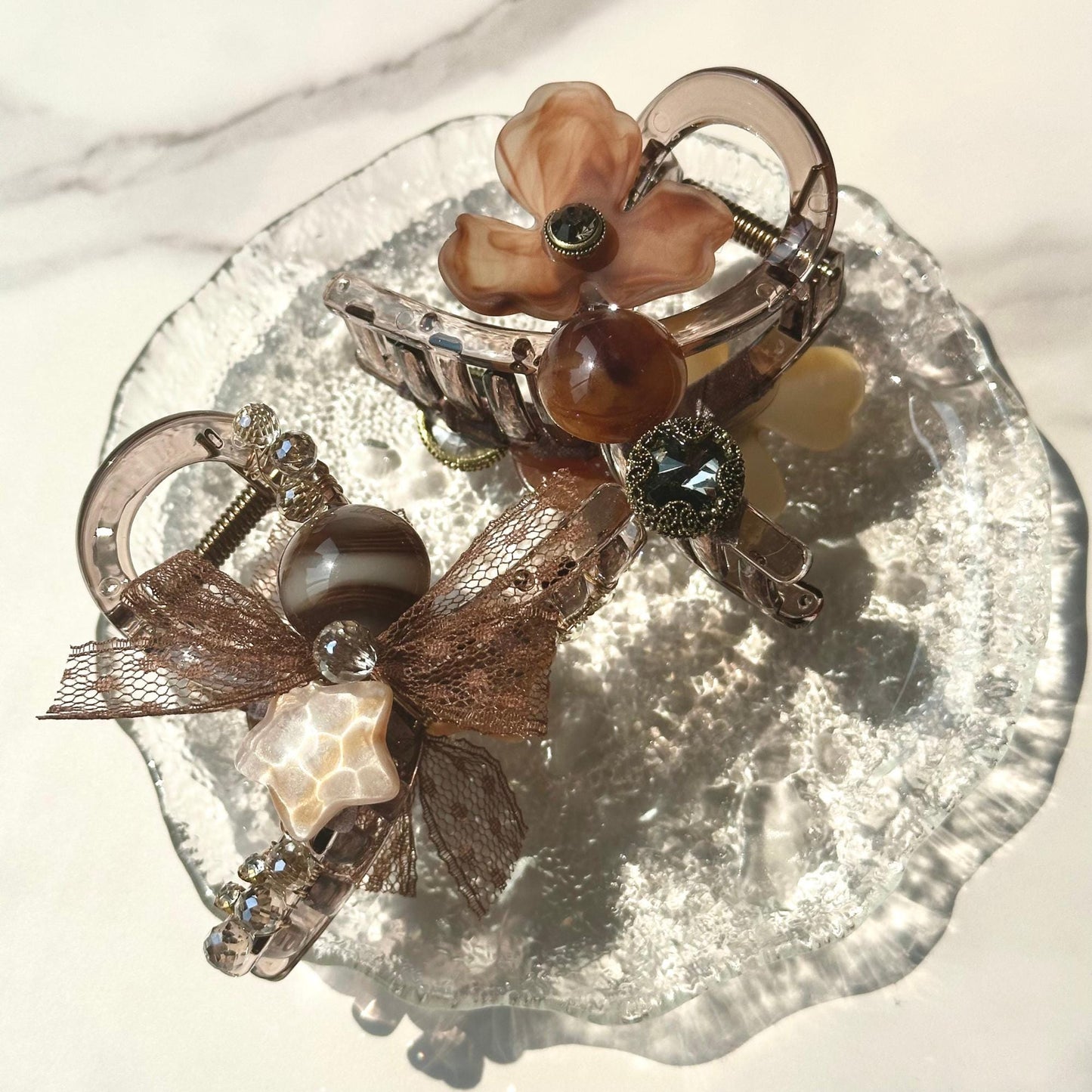 a close up of a glass plate with jewelry on it