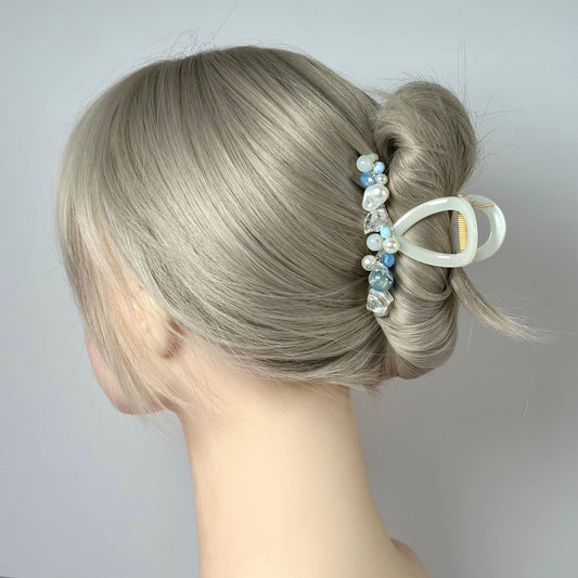 a close up of a woman's head with a hair clip in her hair