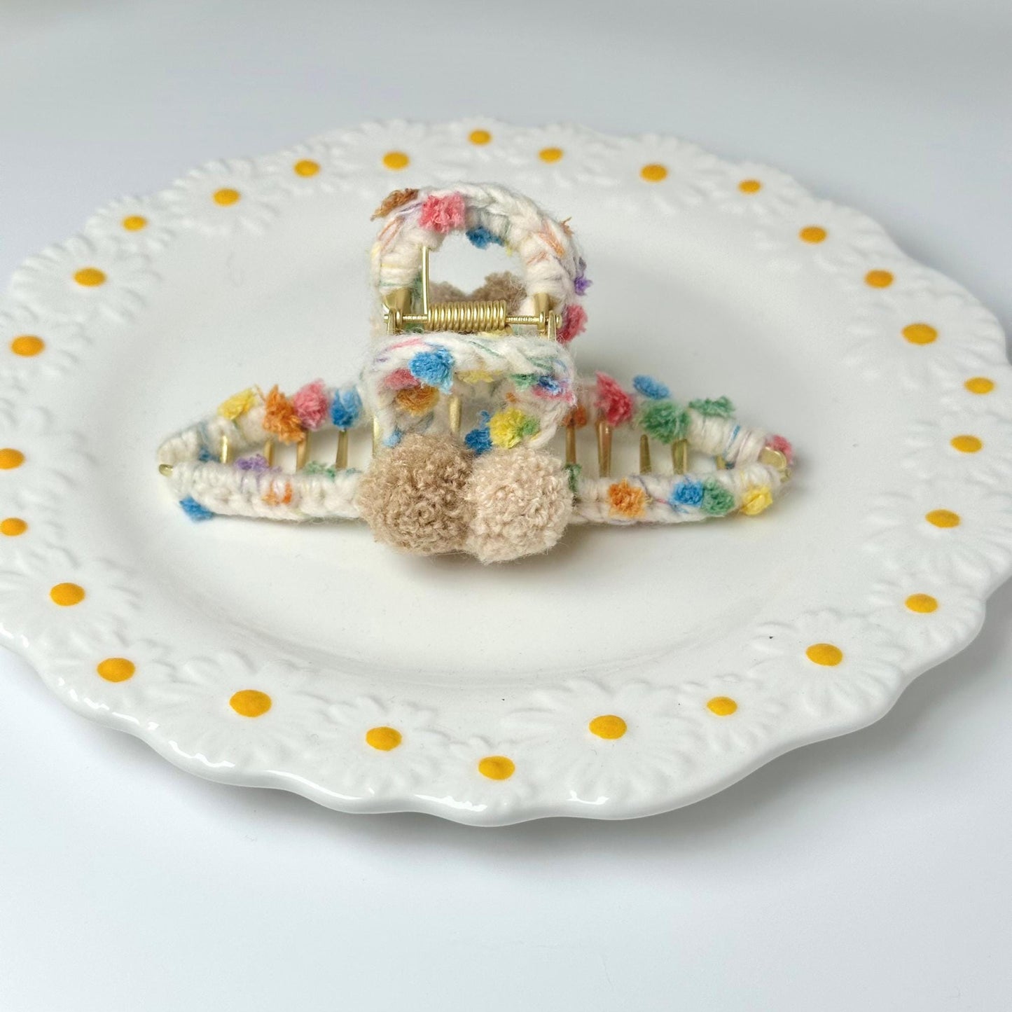 a white plate topped with a hair comb and a hair clip