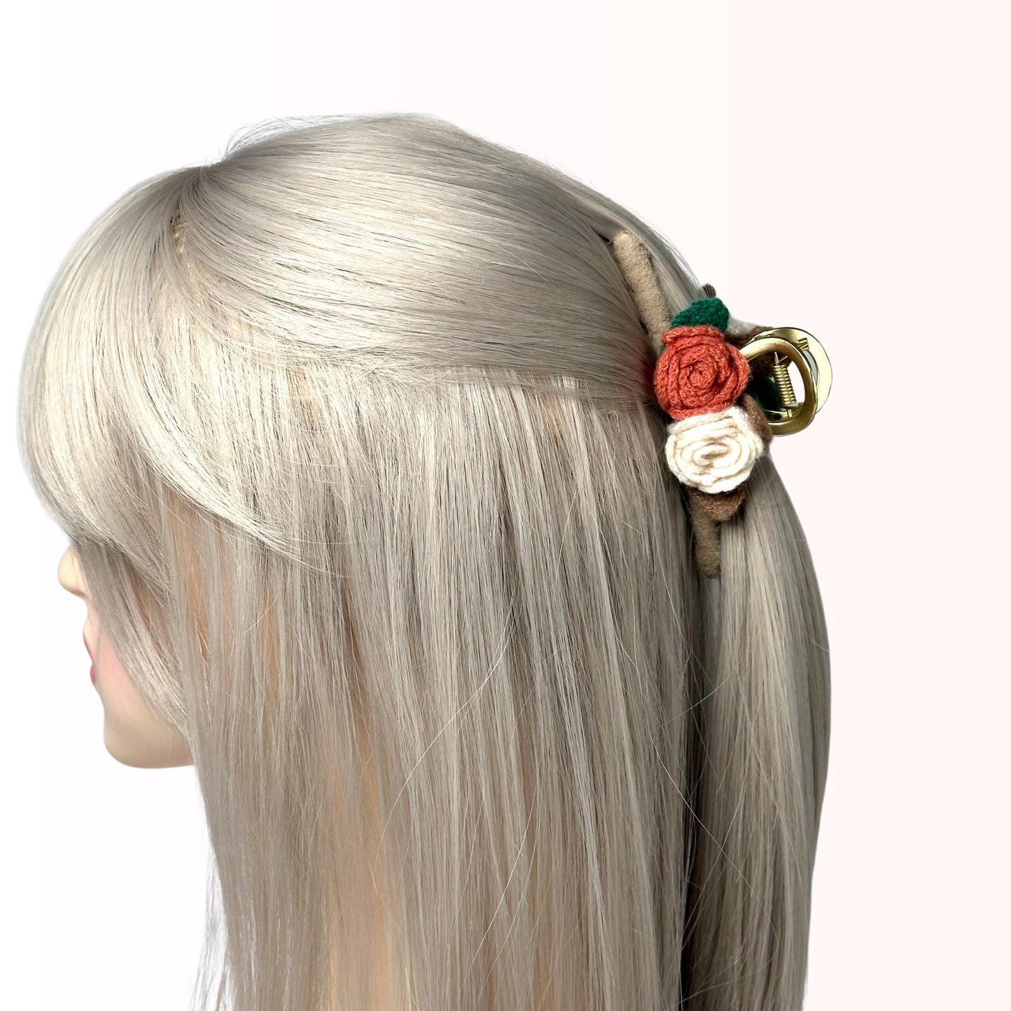 a woman with blonde hair and a flower in her hair