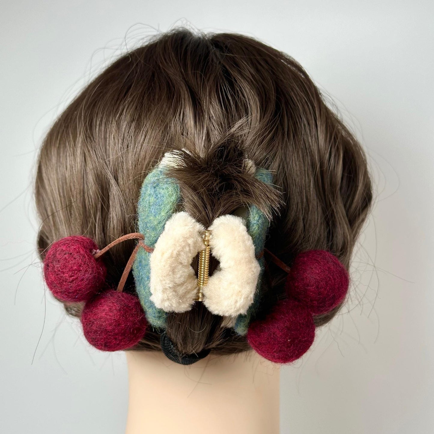 a woman's head with a piece of hair on top of it