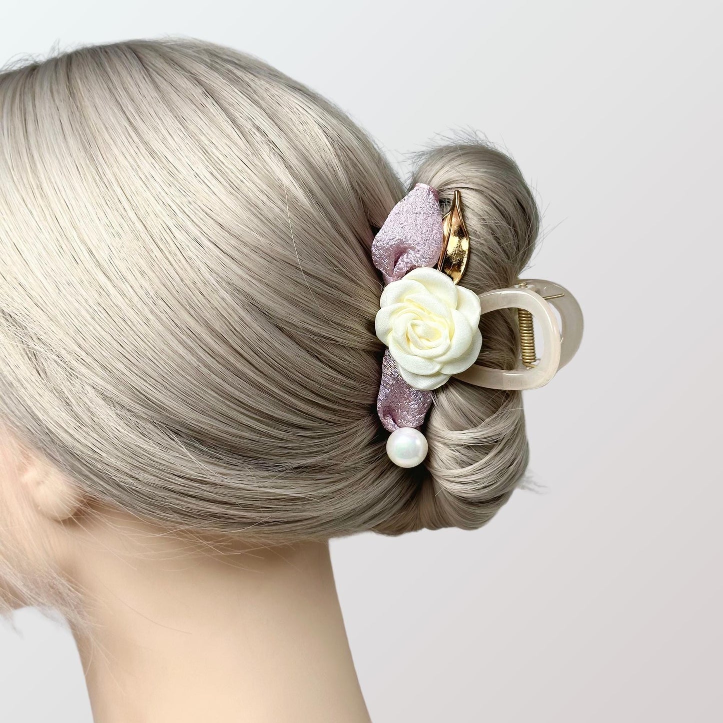 a close up of a woman with a hair clip in her hair