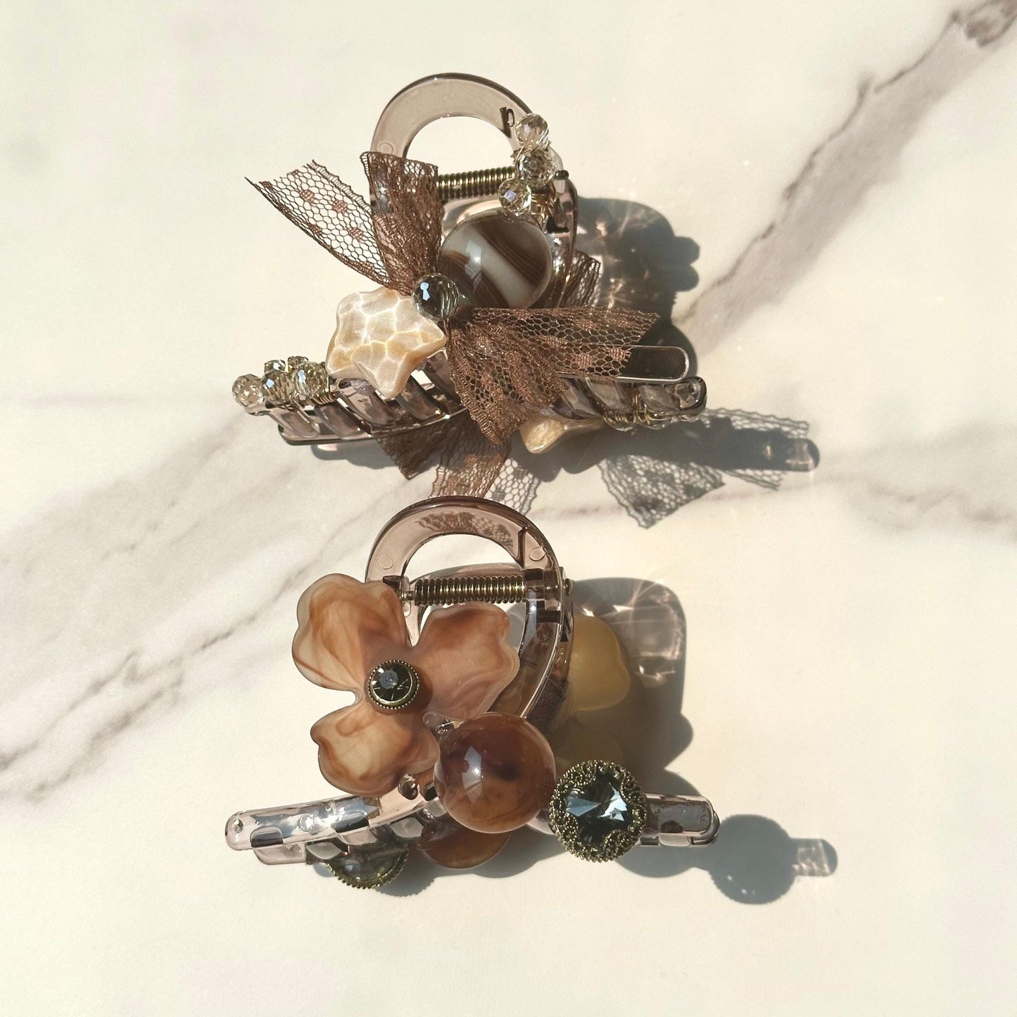 a close up of two brooches on a table