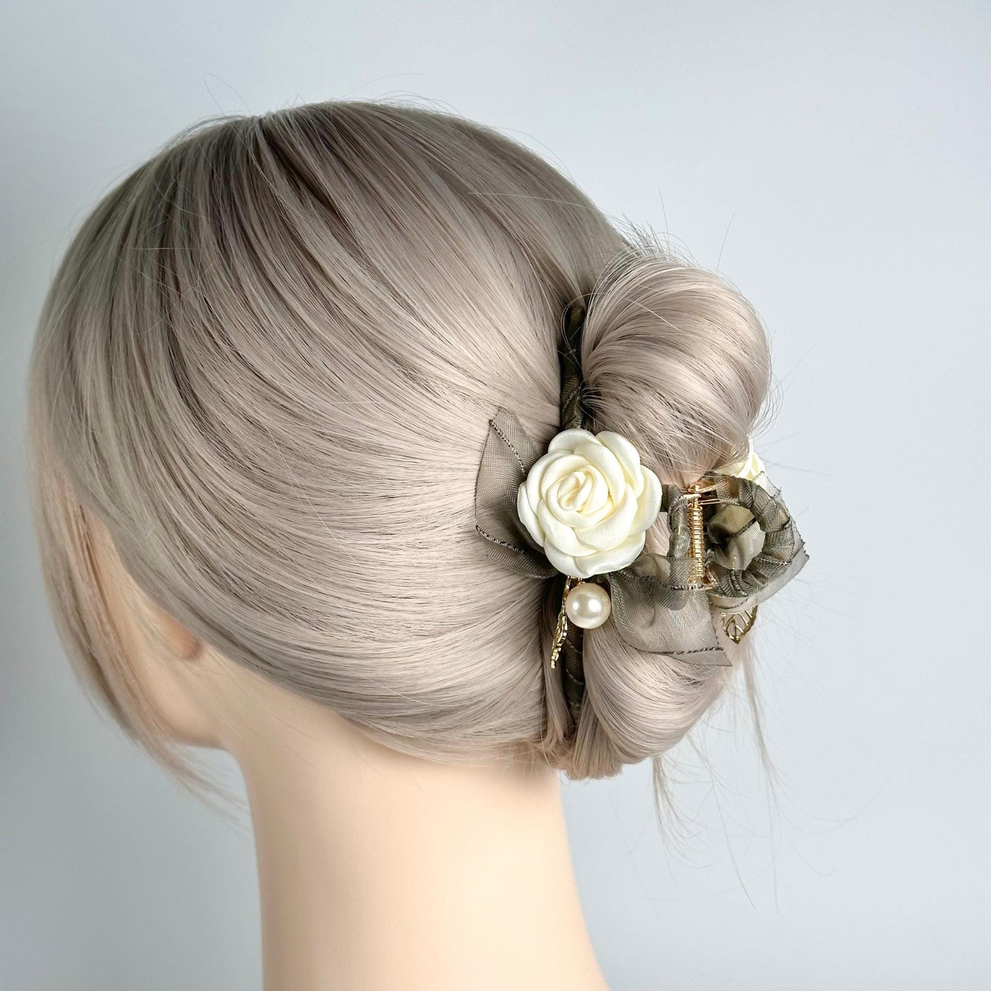 a close up of a mannequin head with a flower in it