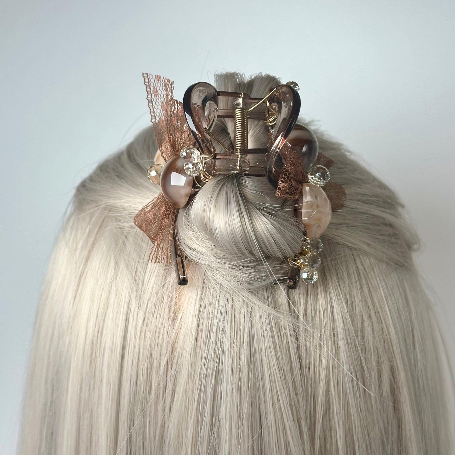 a woman with blonde hair wearing a hair clip