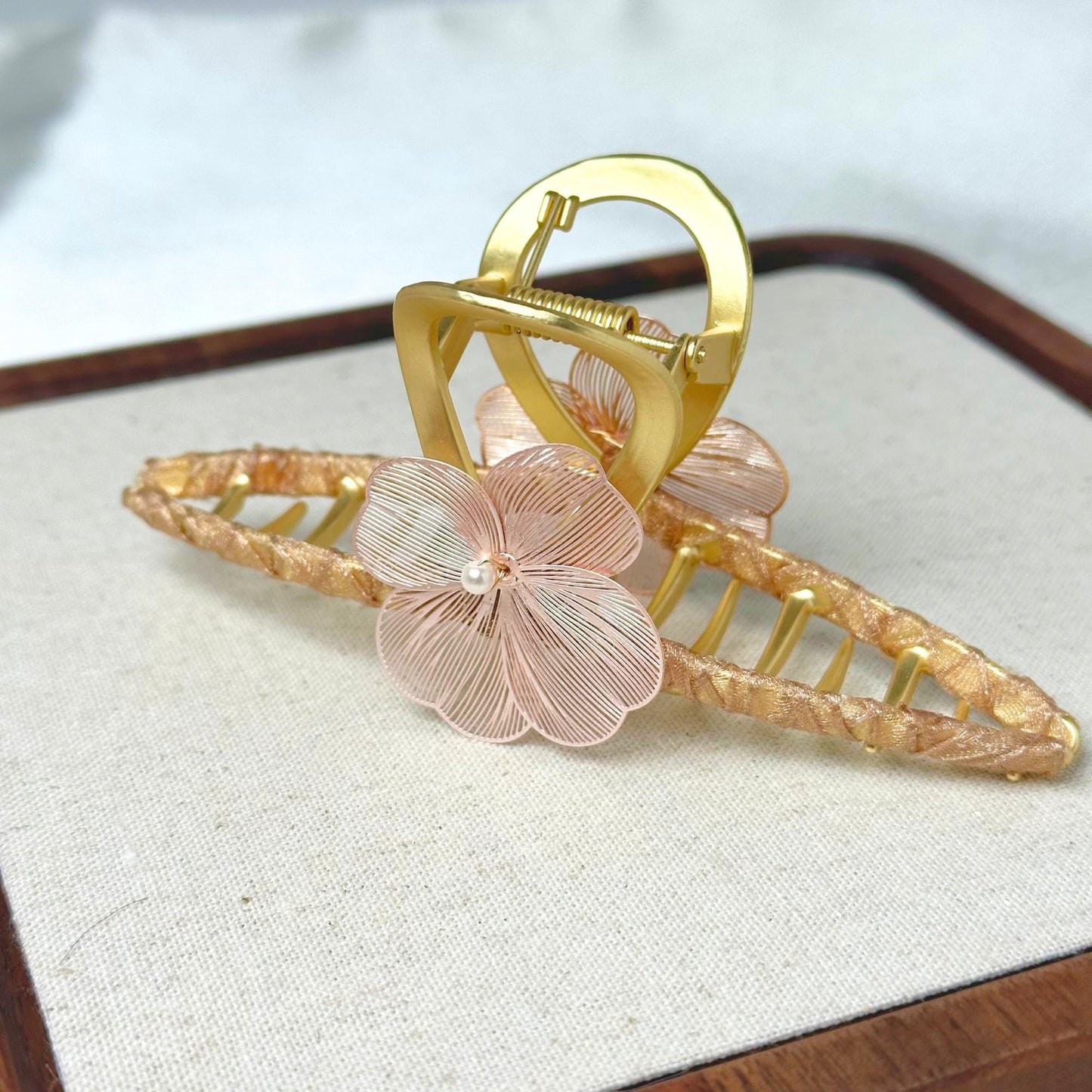 a close up of a brooch with a flower on it