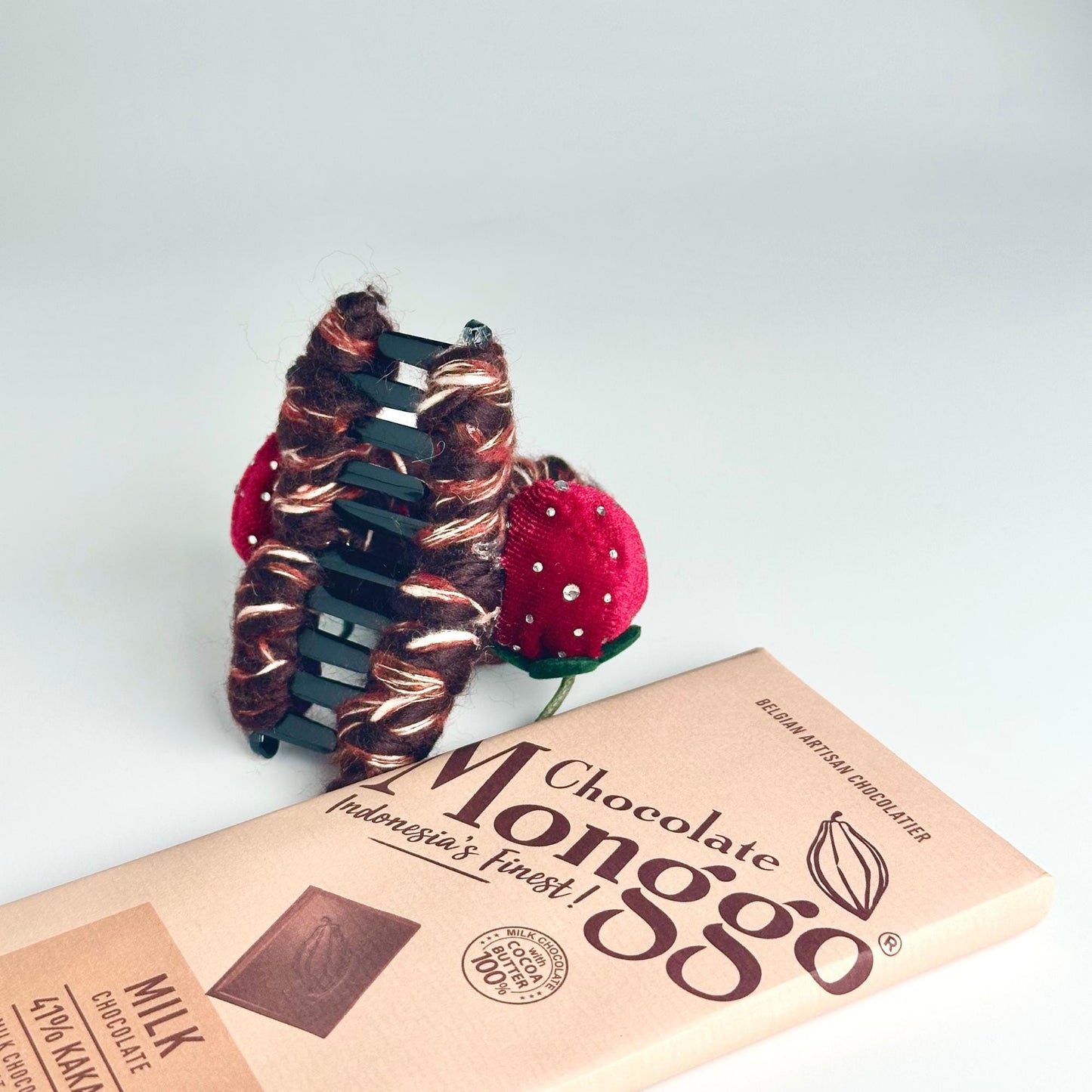 a chocolate bar with two strawberries on top of it