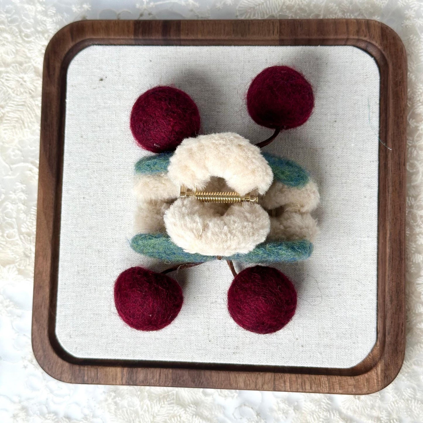 a small stuffed animal with two balls of yarn