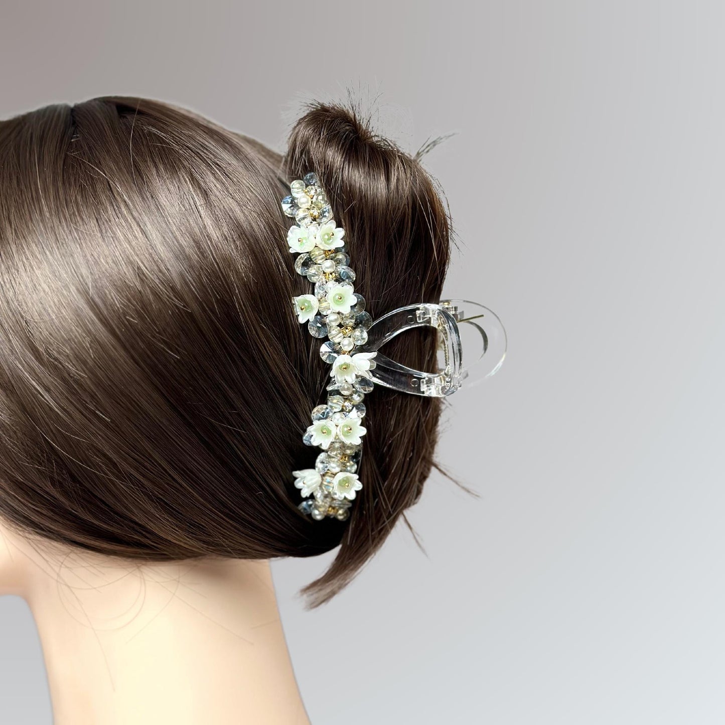 a close up of a woman's head wearing a hair comb