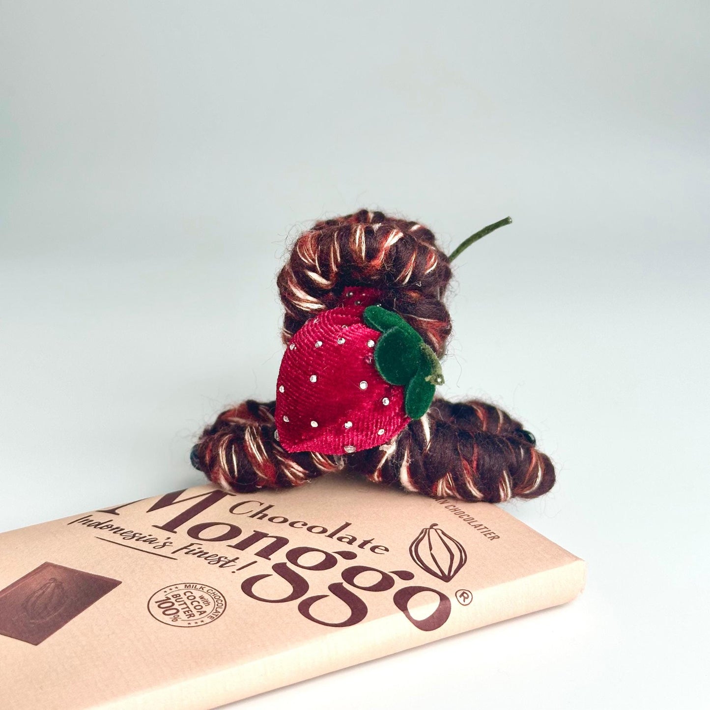 a red flower sitting on top of a book