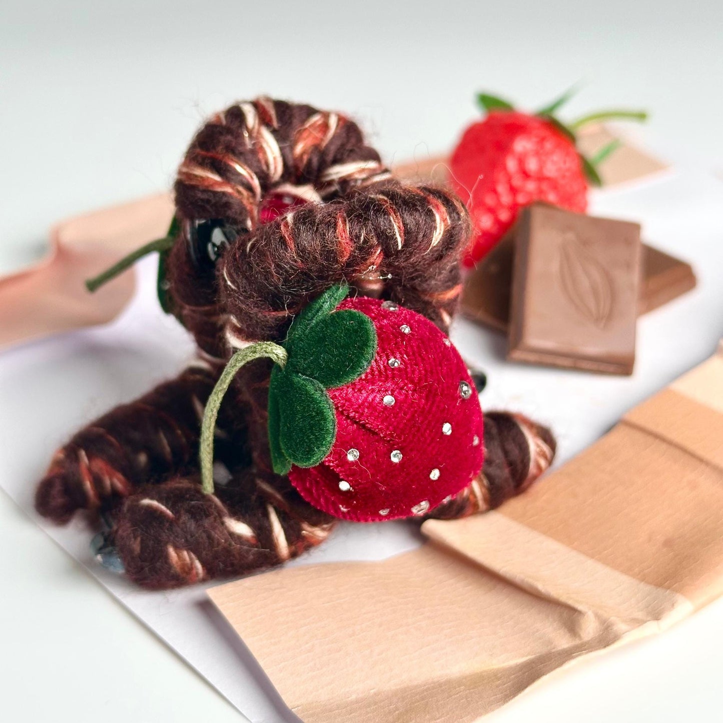 a stuffed animal with a strawberry on top of it