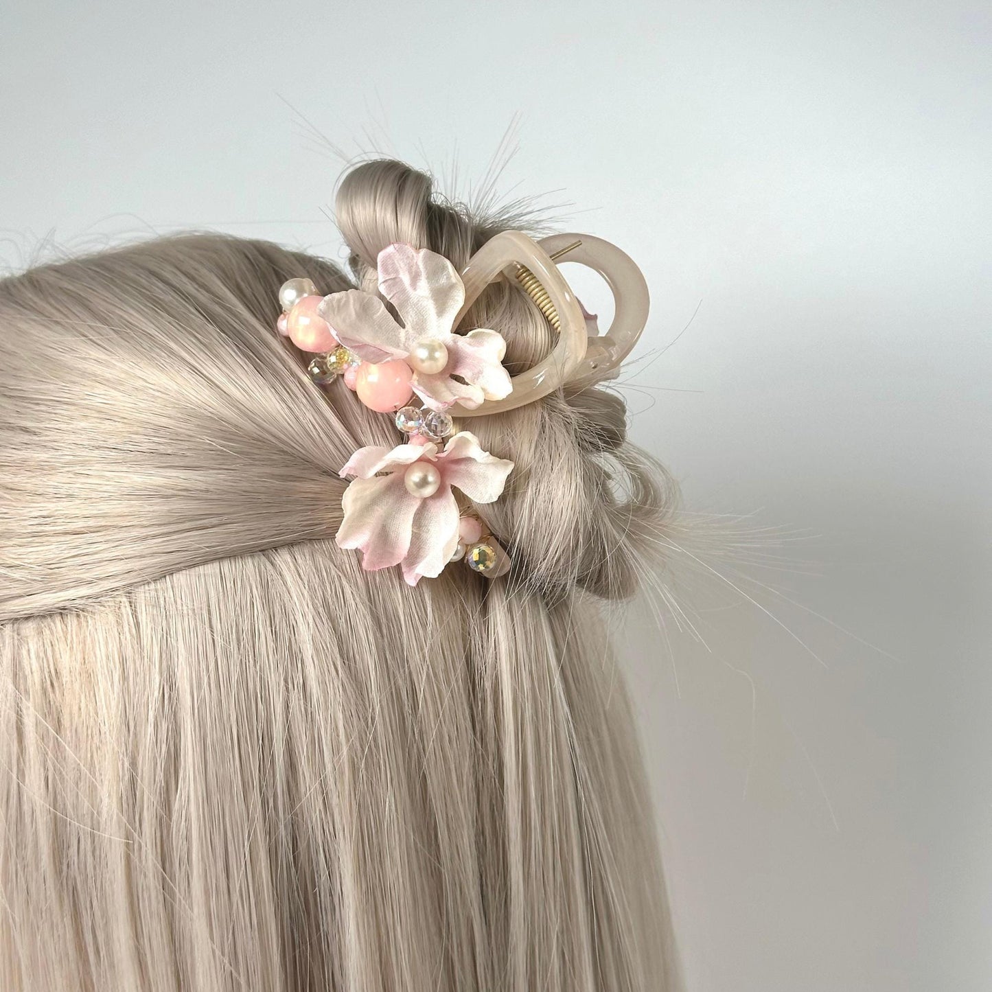 a woman with blonde hair and a flower in her hair