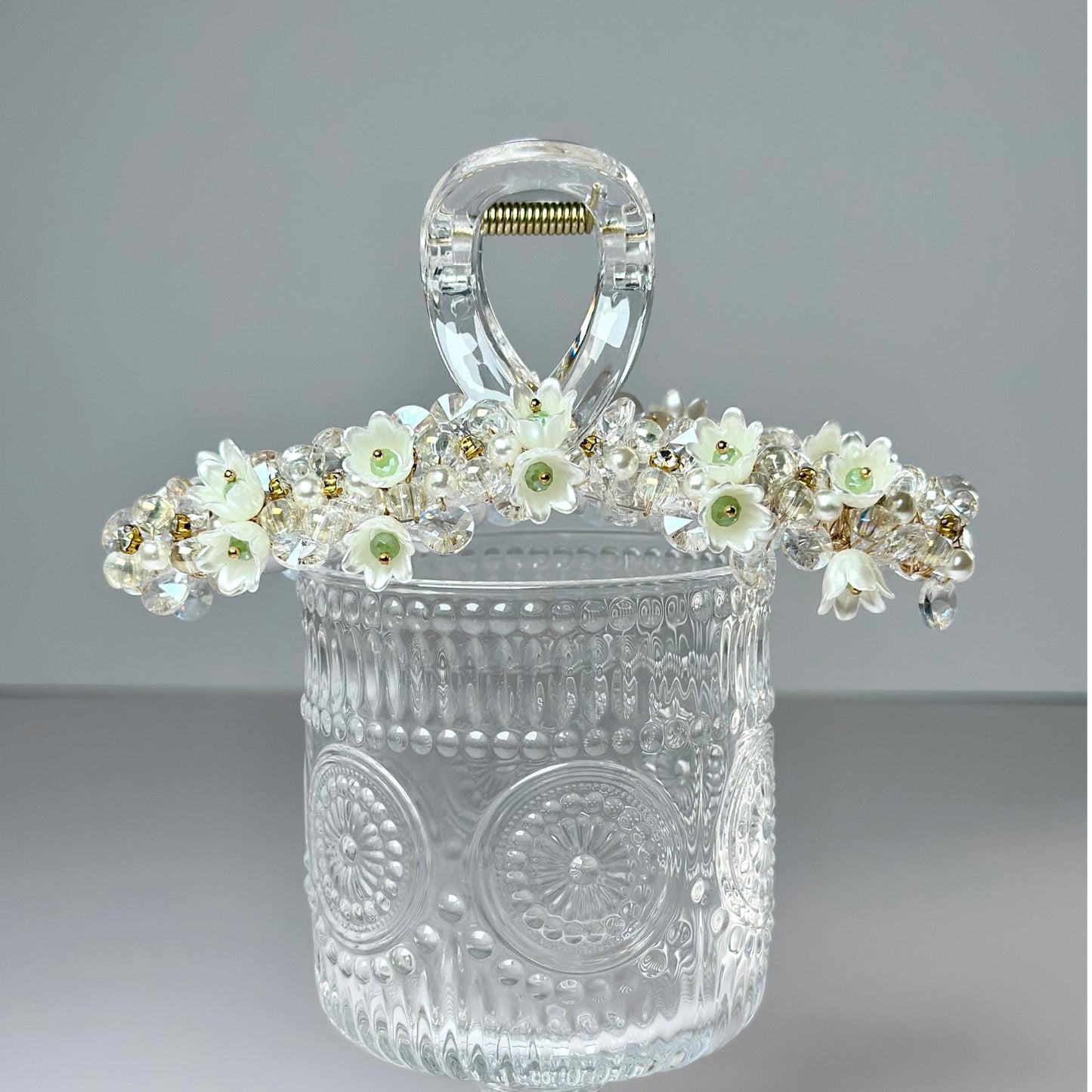 a clear glass container with flowers in it