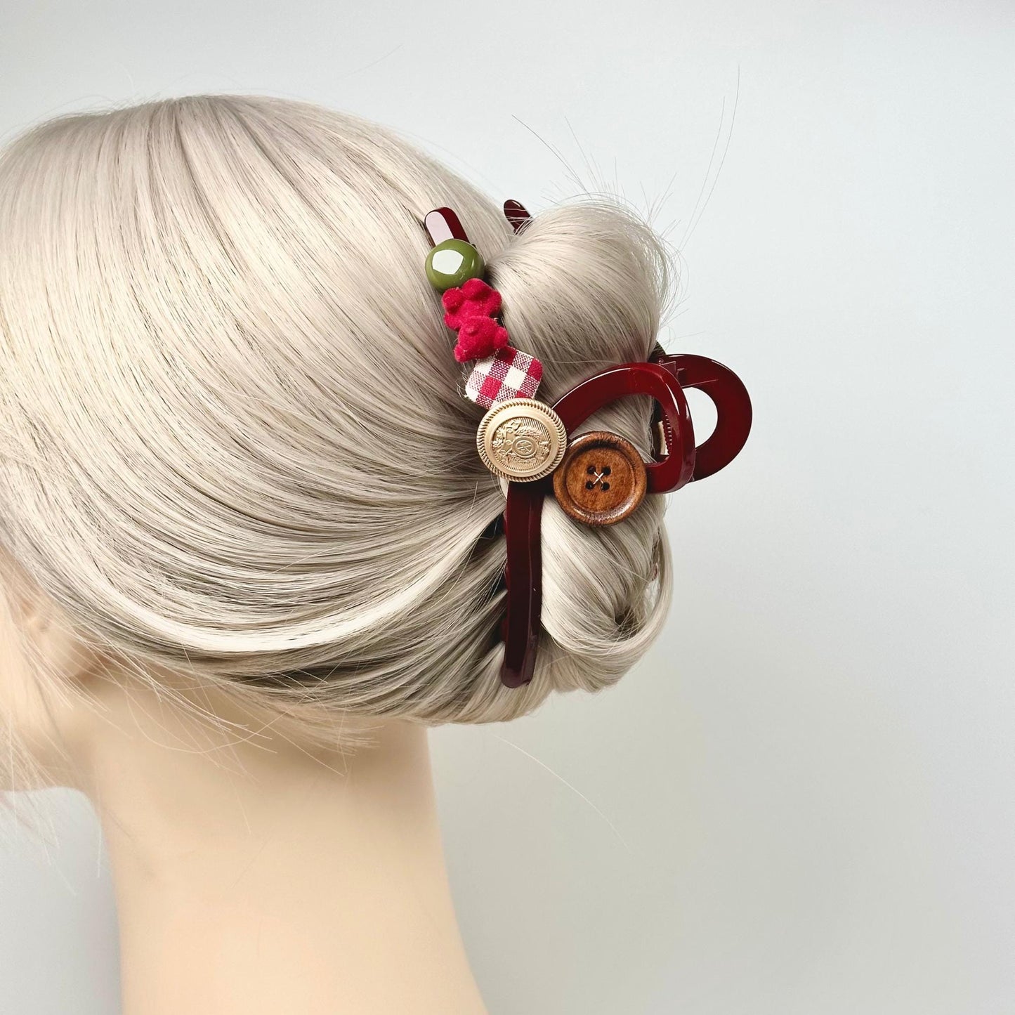 a woman's hair is styled with a hair pin