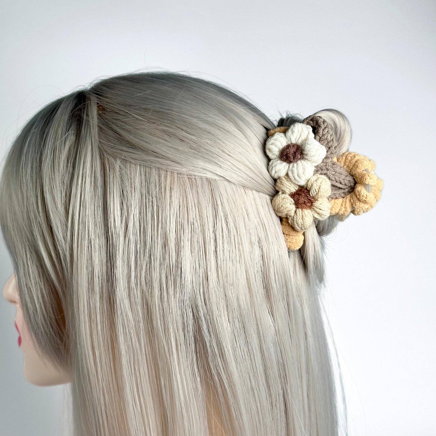 a woman with blonde hair and a flower in her hair