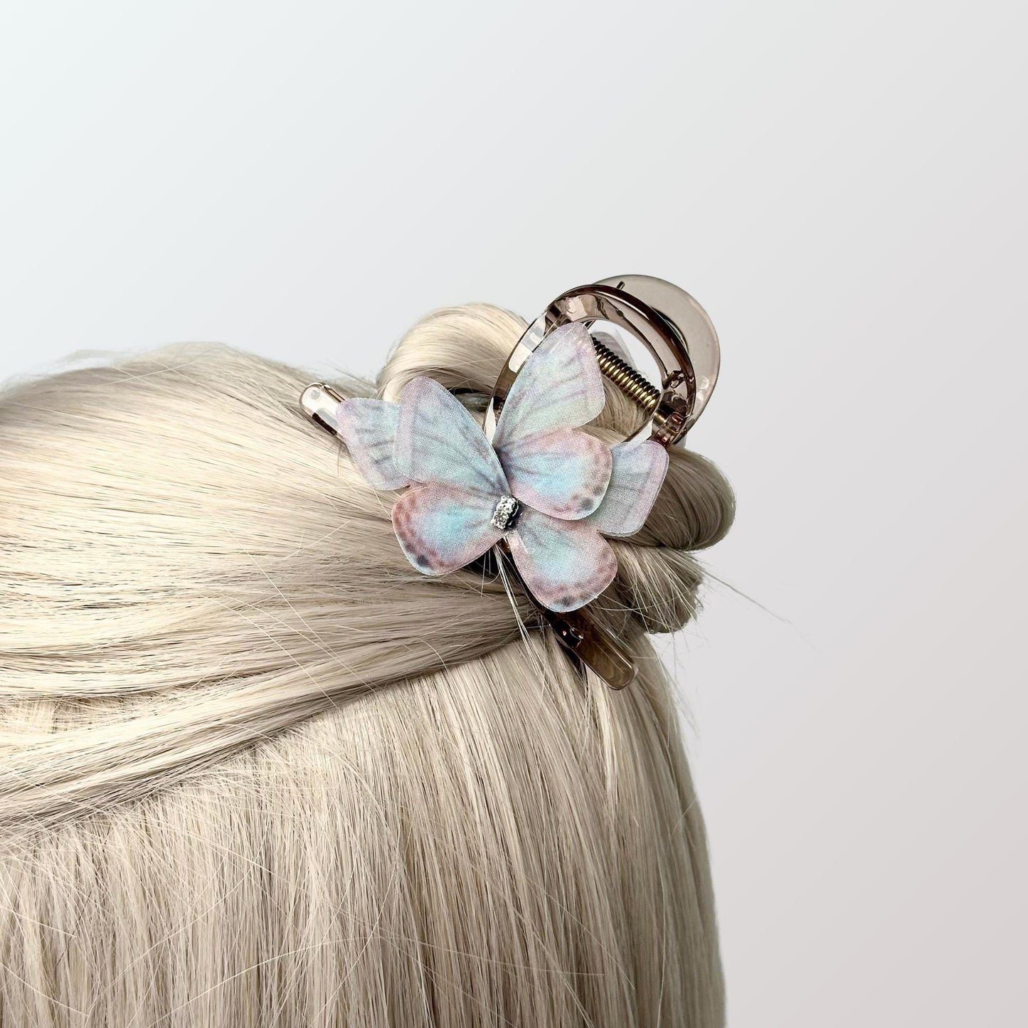 a close up of a hair with a butterfly on it