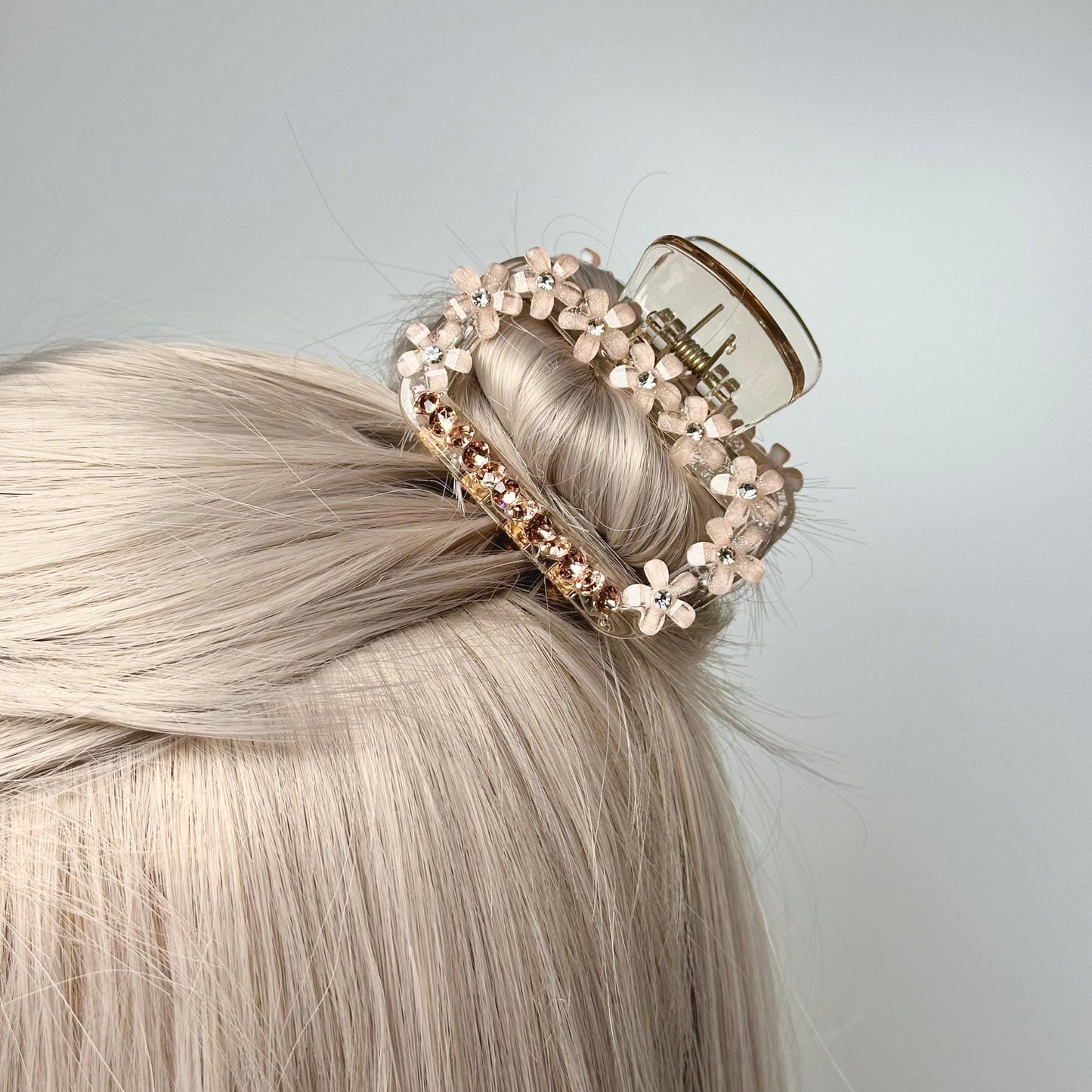 a woman with blonde hair wearing a hair clip