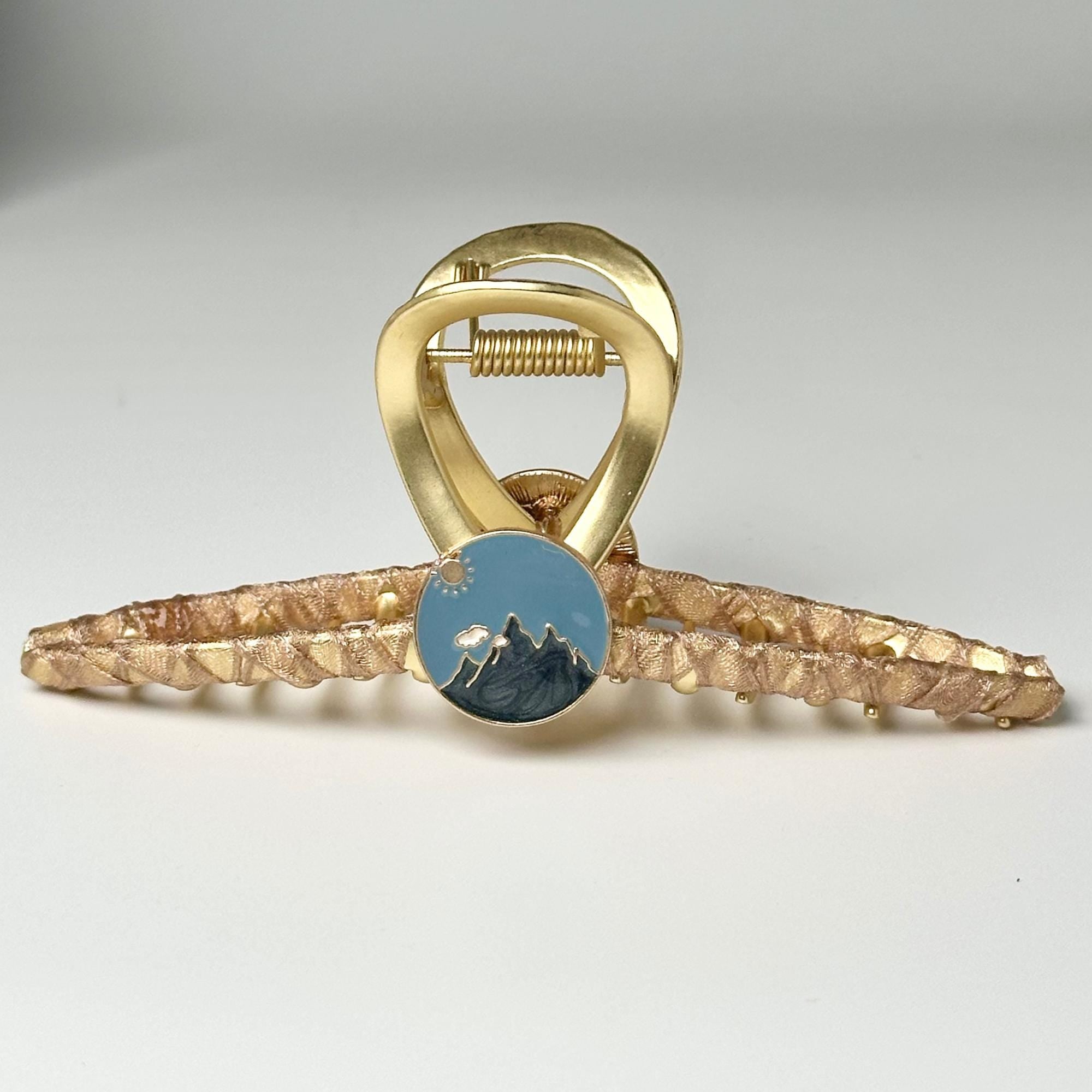 a gold ring with a blue stone in the middle