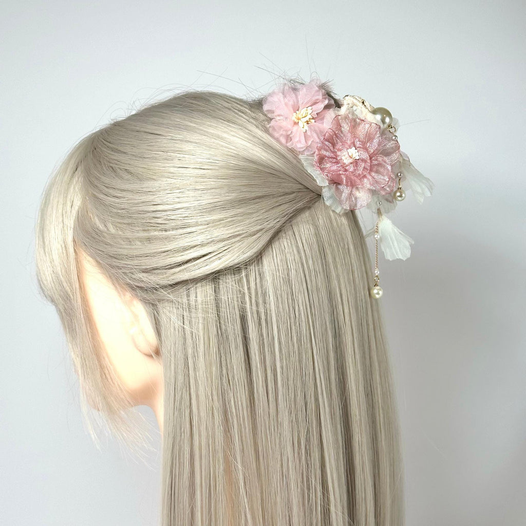 a blonde woman with a flower in her hair