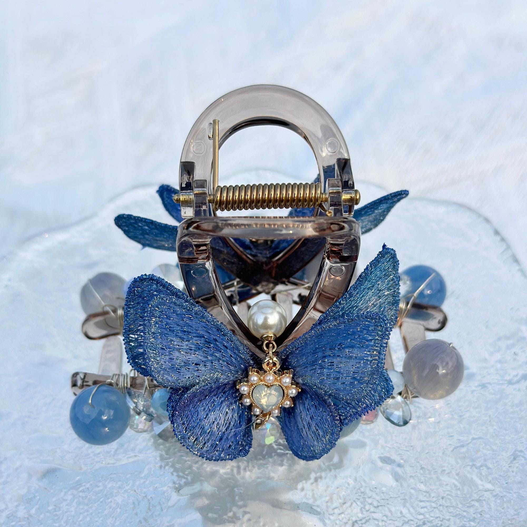a close up of a blue butterfly brooch